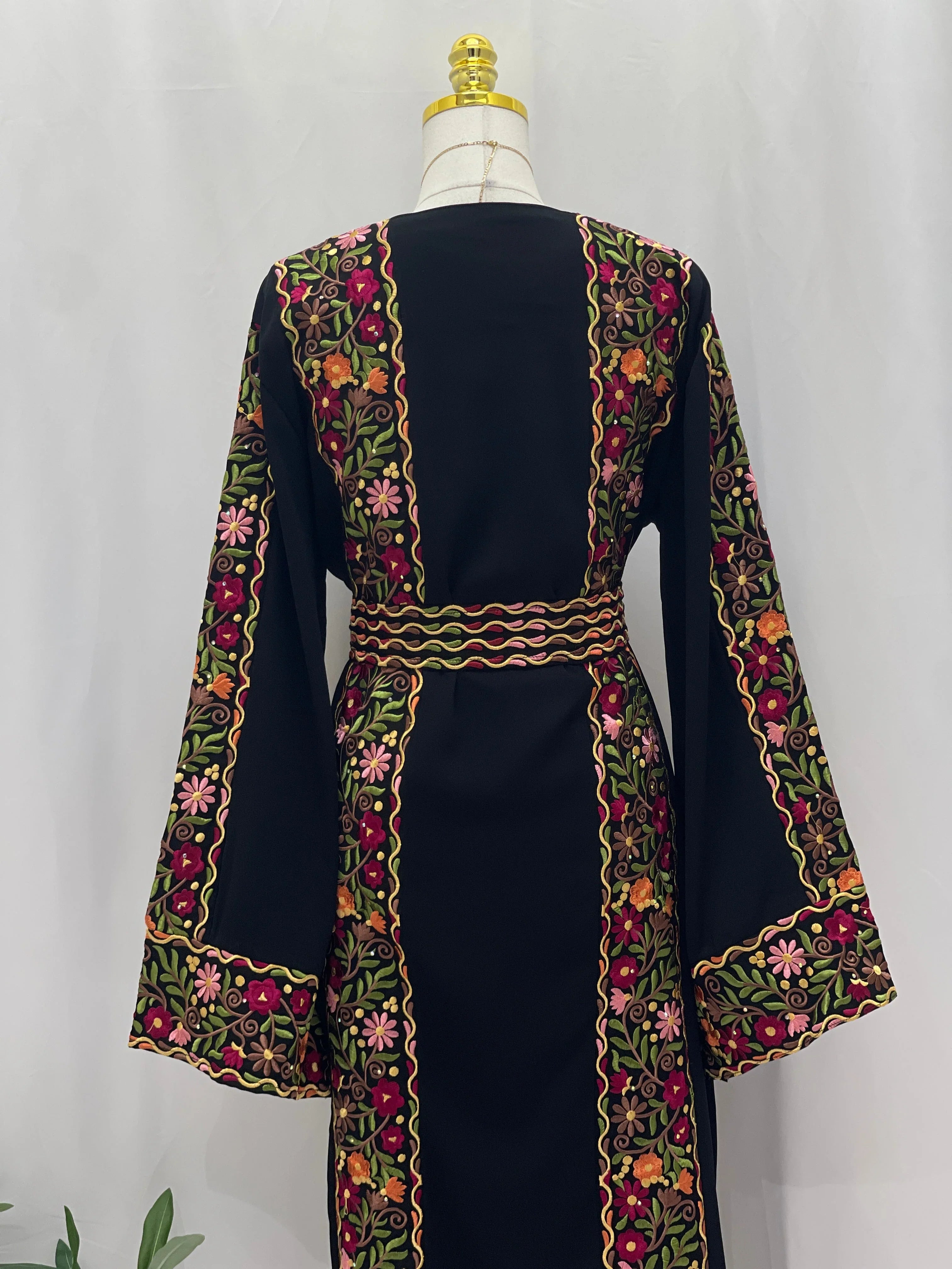 Back view of Floral Essence Embroidered Thobe featuring vibrant floral designs and elegant detailing