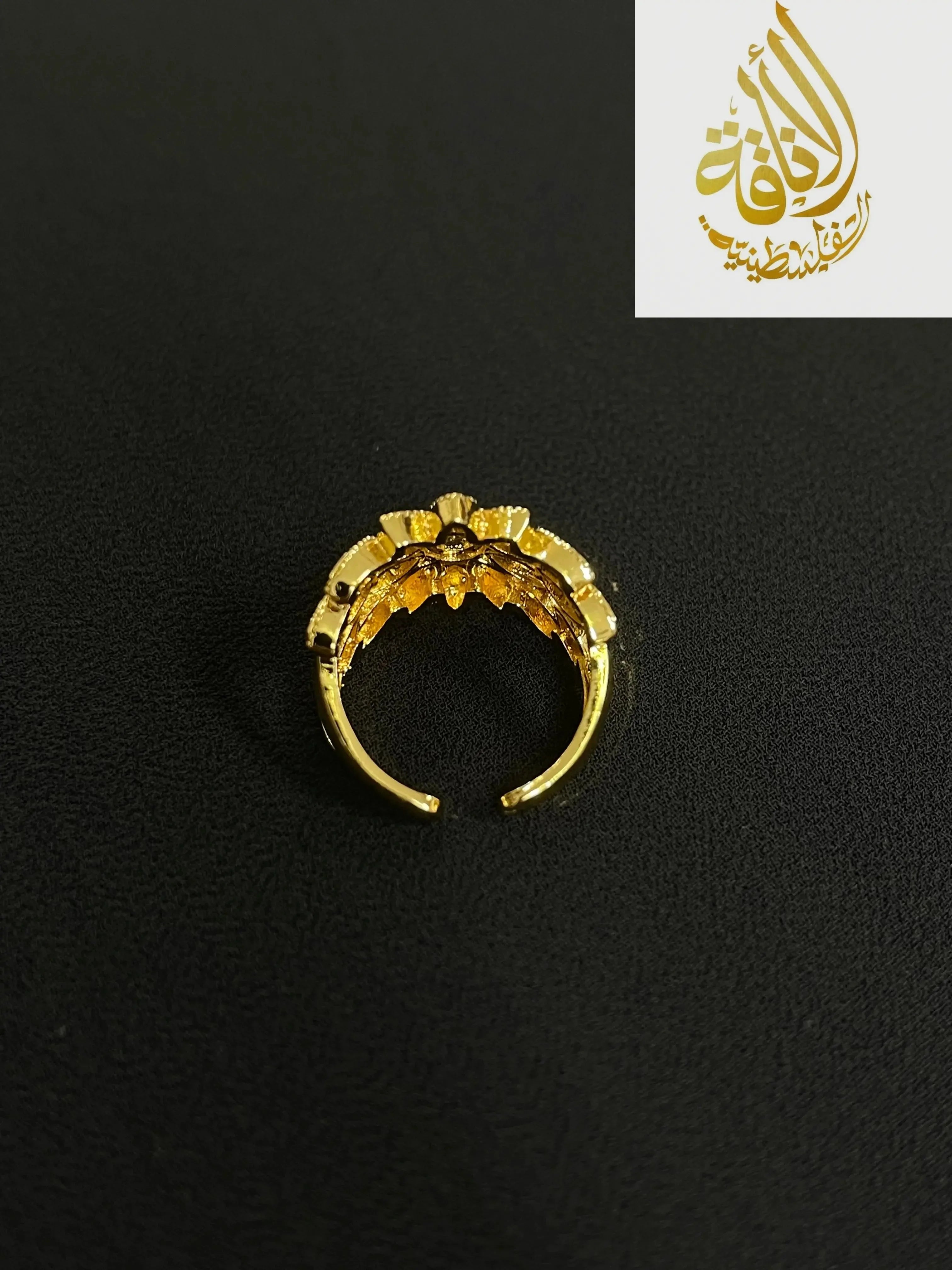 Palestinian gold jewelry set featuring a delicate gold ring with intricate floral design by Palestinian Elegance