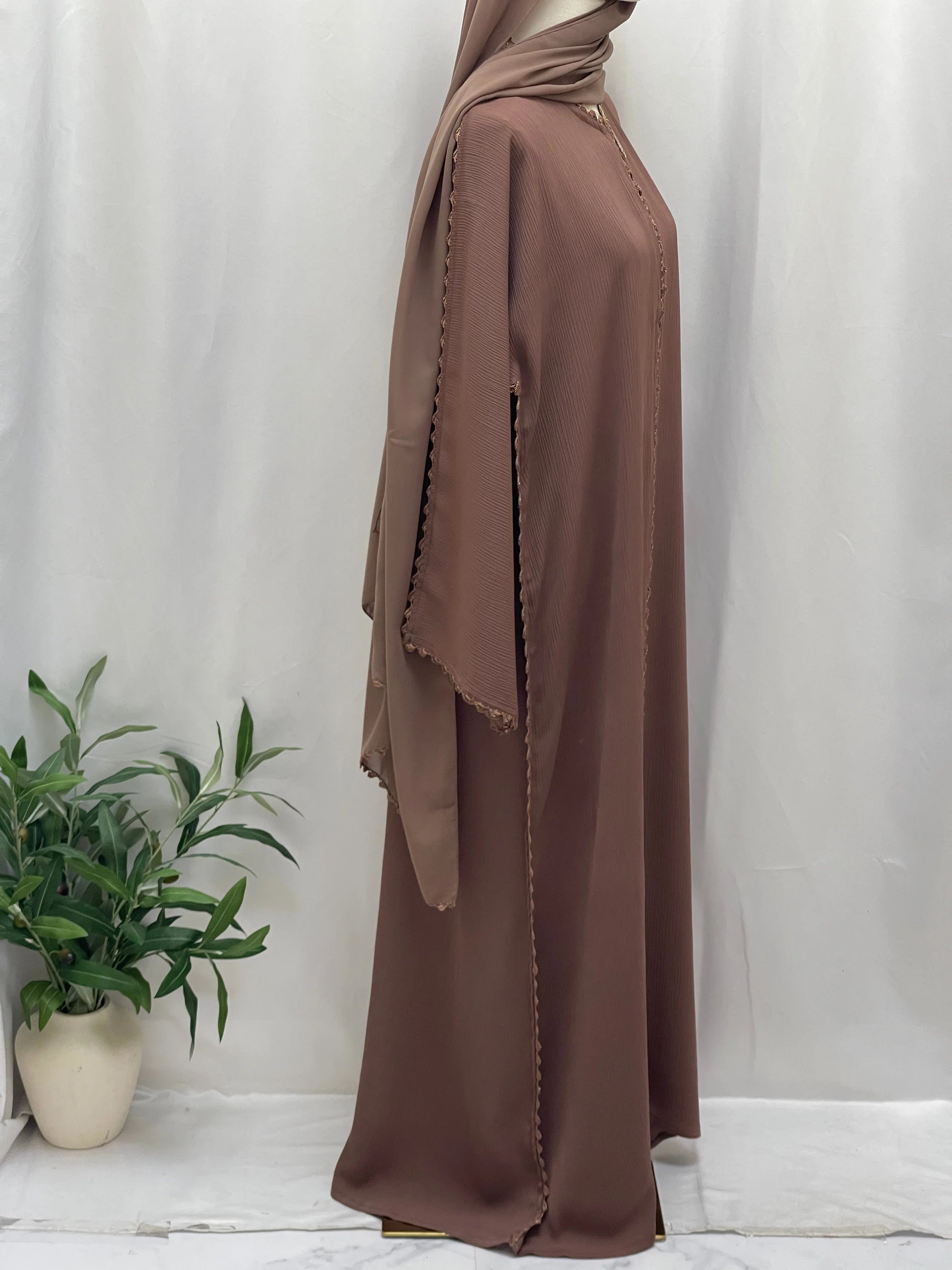Palestinian Elegance Ghosoon Abaya in brown with detailed trim and flowing fabric styling