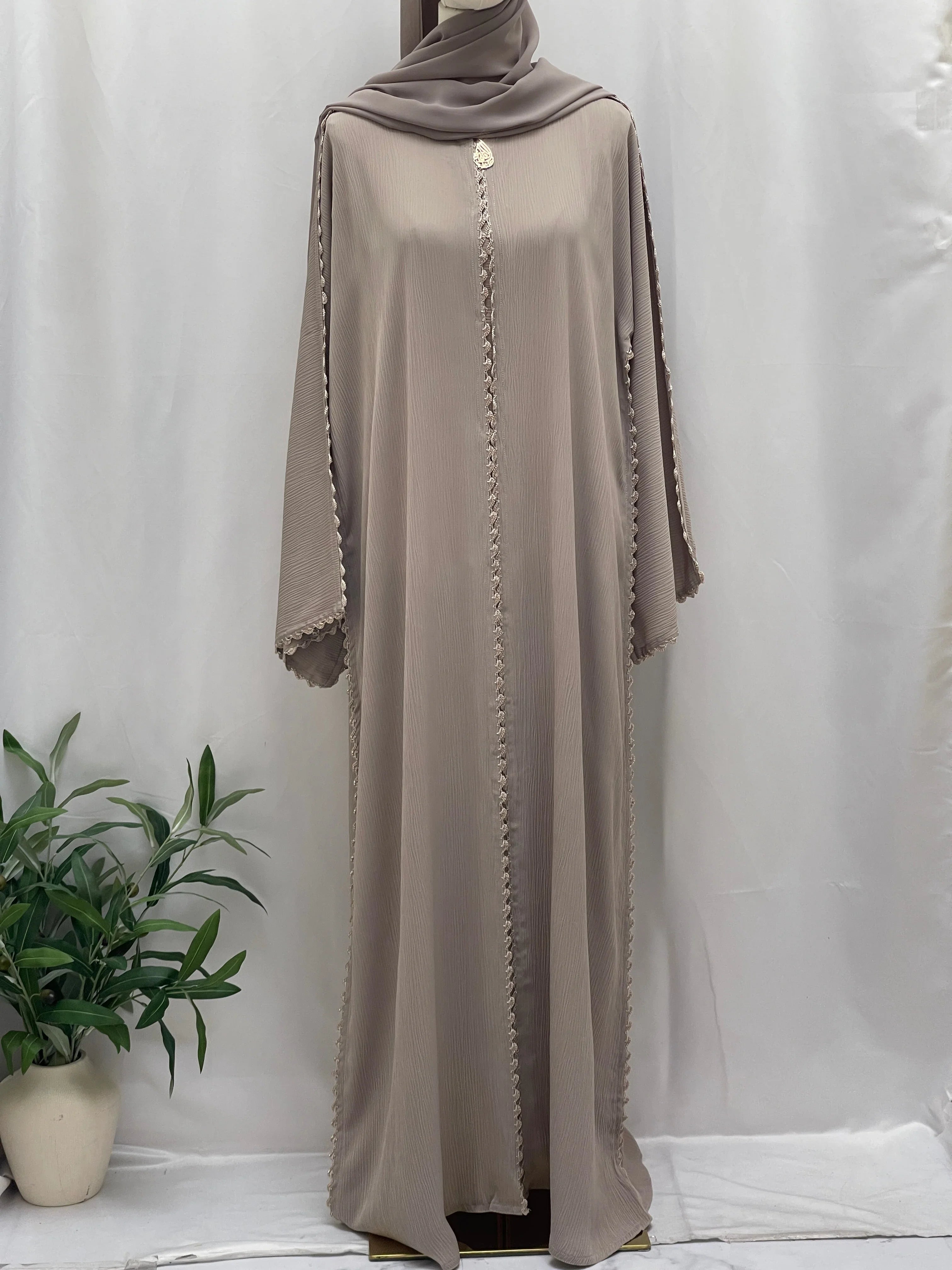 Palestinian Elegance Ghosoon Abaya in soft beige with detailed trim design on sleeves and front