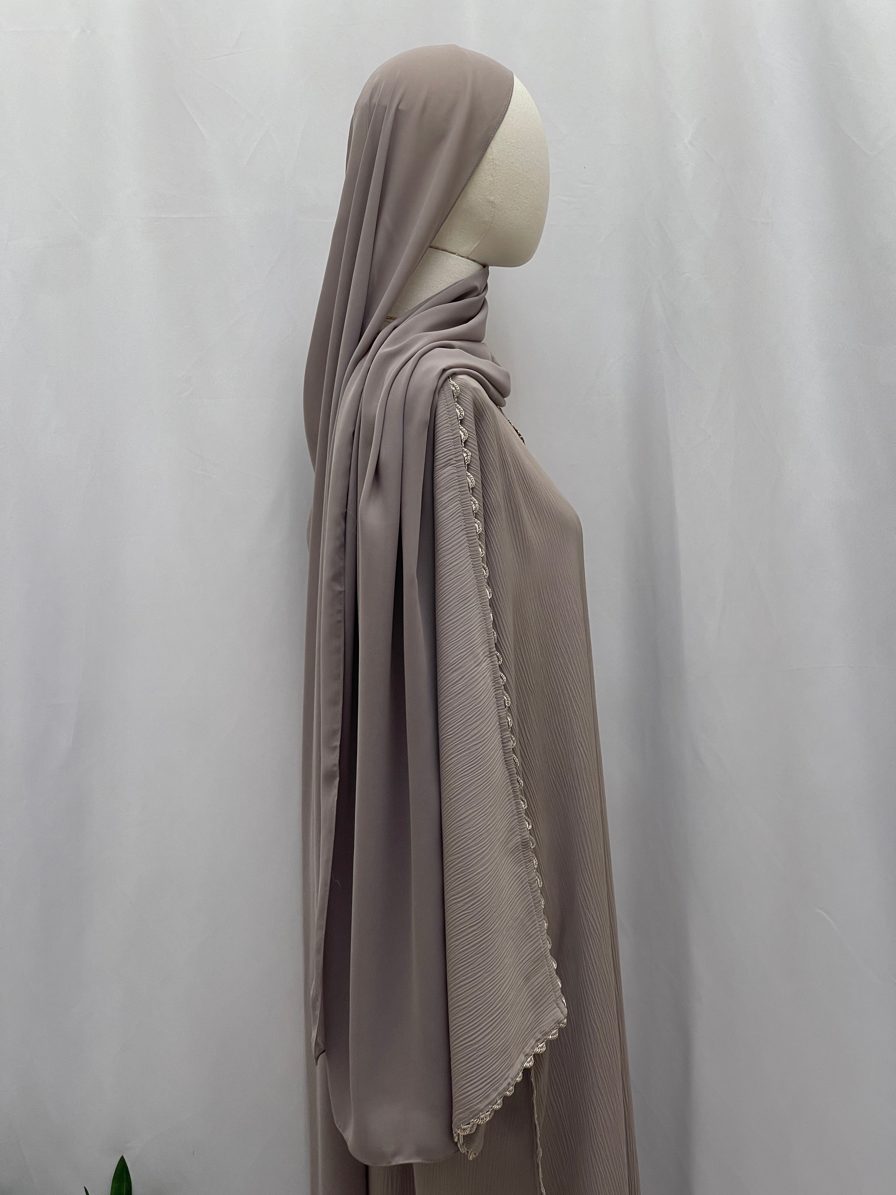 Palestinian Elegance Ghosoon Abaya in taupe with delicate lace trim on sleeve, displayed on mannequin