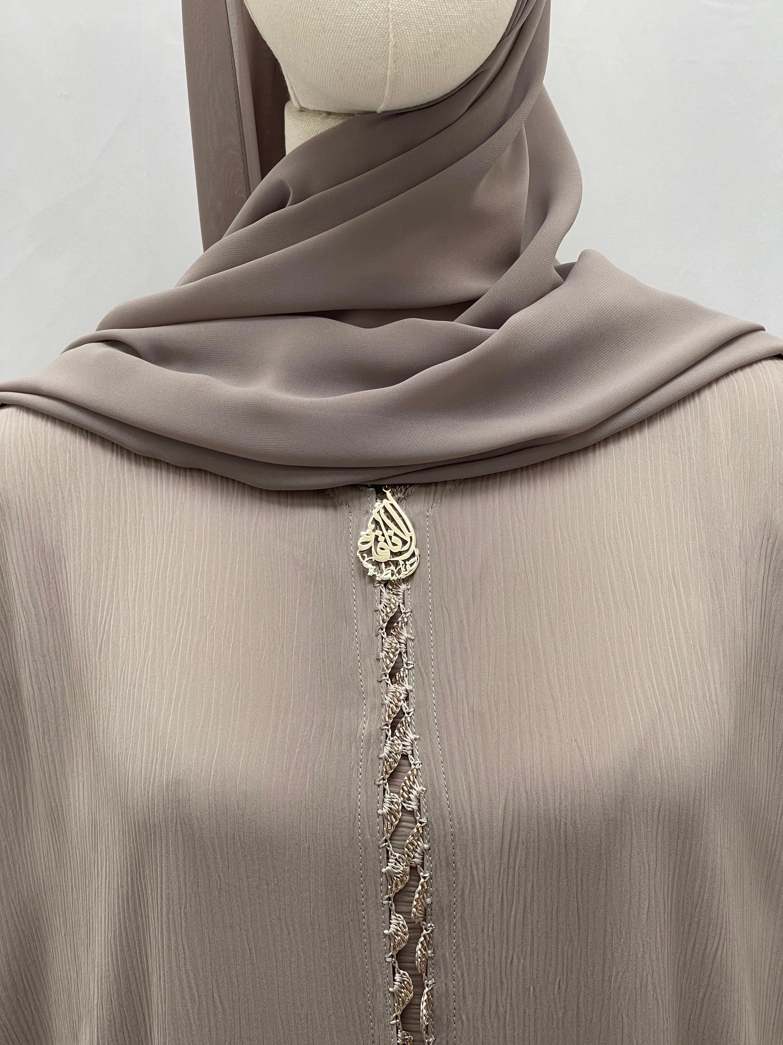 Palestinian Elegance Ghosoon Abaya in soft taupe fabric with intricate front embellishment and matching hijab