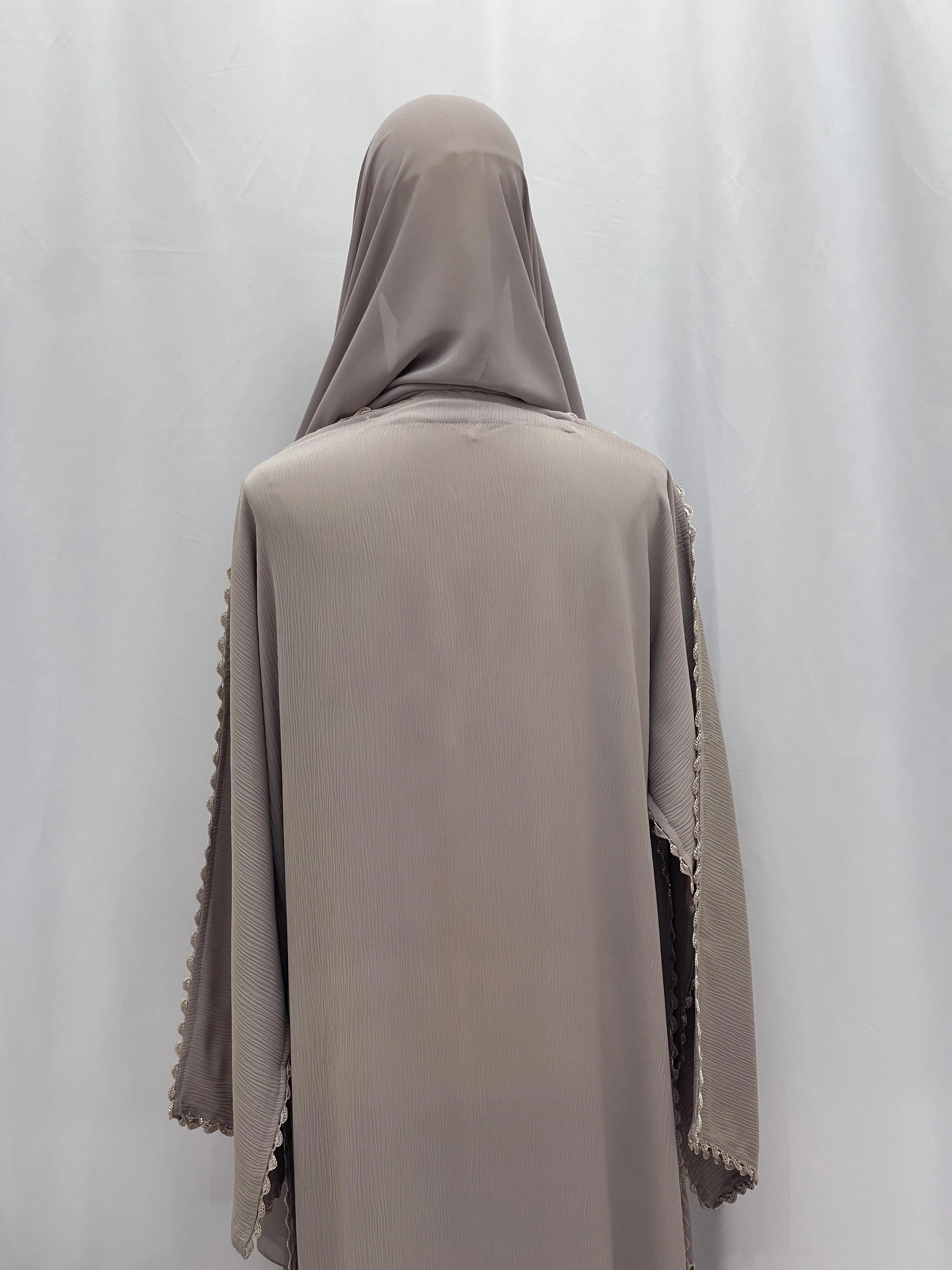Back view of Palestinian Elegance Ghosoon Abaya in taupe with detailed sleeve trimming and hijab.