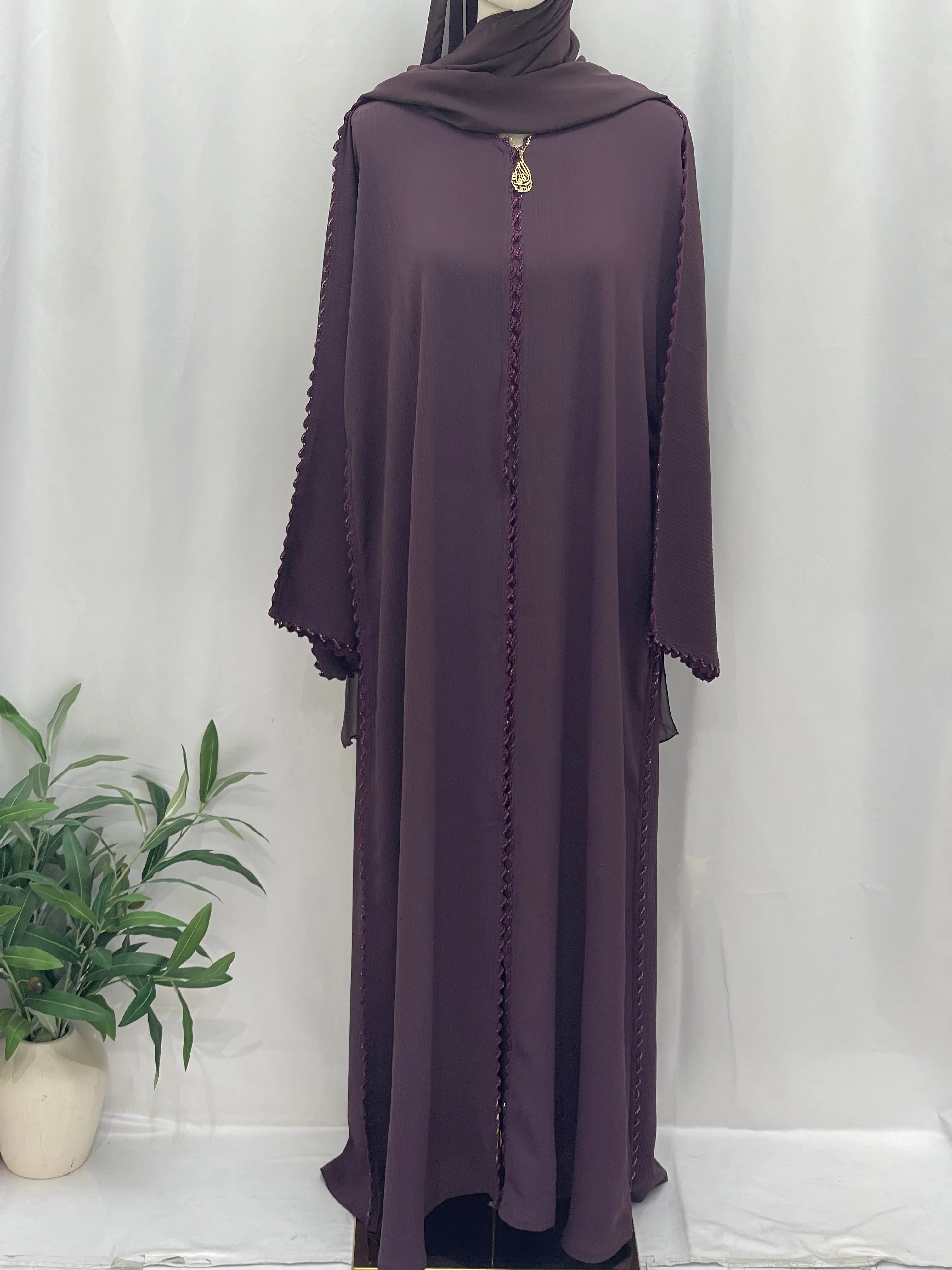 Palestinian Elegance Ghosoon Abaya in deep purple with braided edge detail and loose fit design