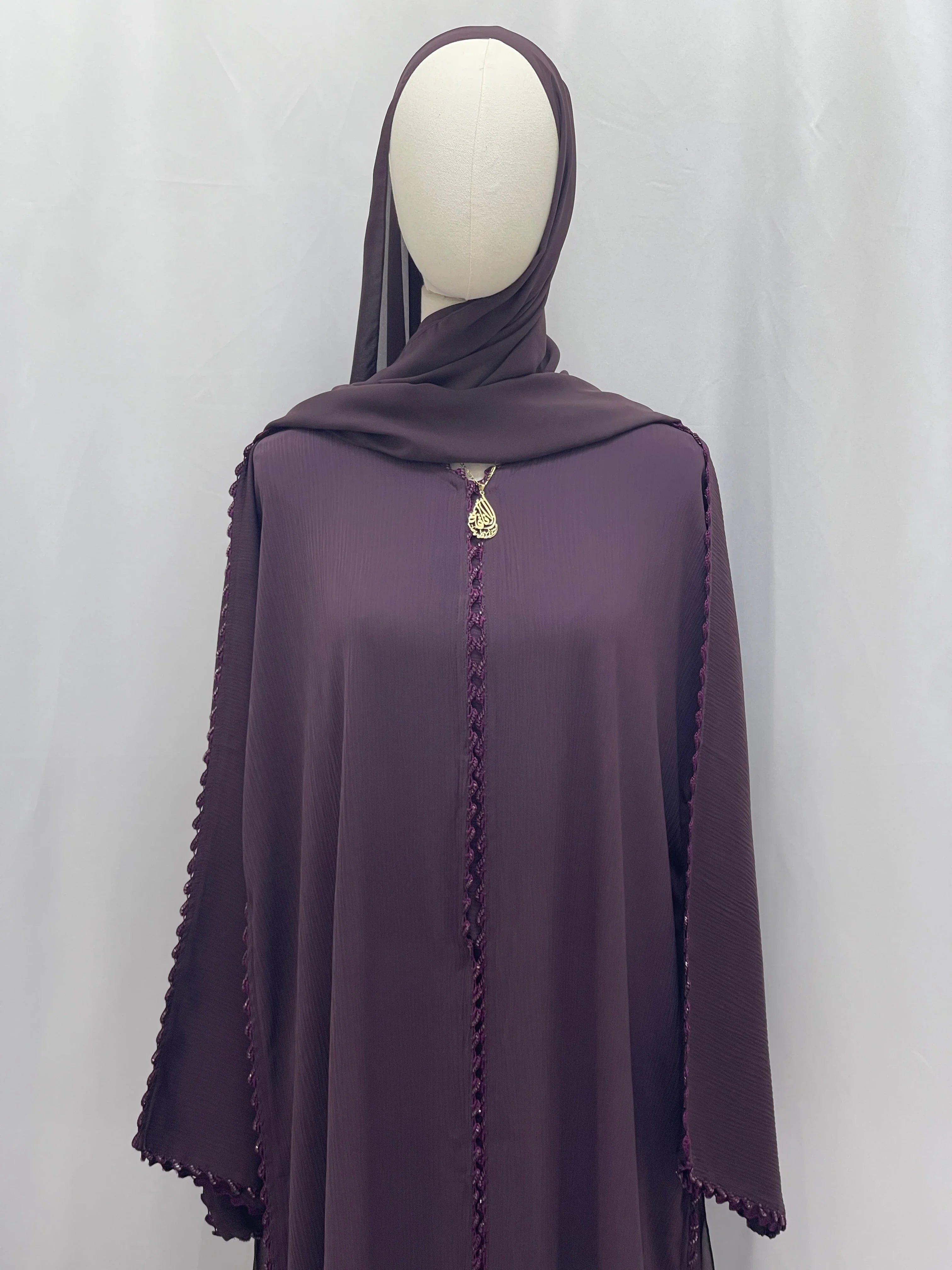 Palestinian Elegance Ghosoon Abaya in deep purple with delicate braided trim and gold pendant detail