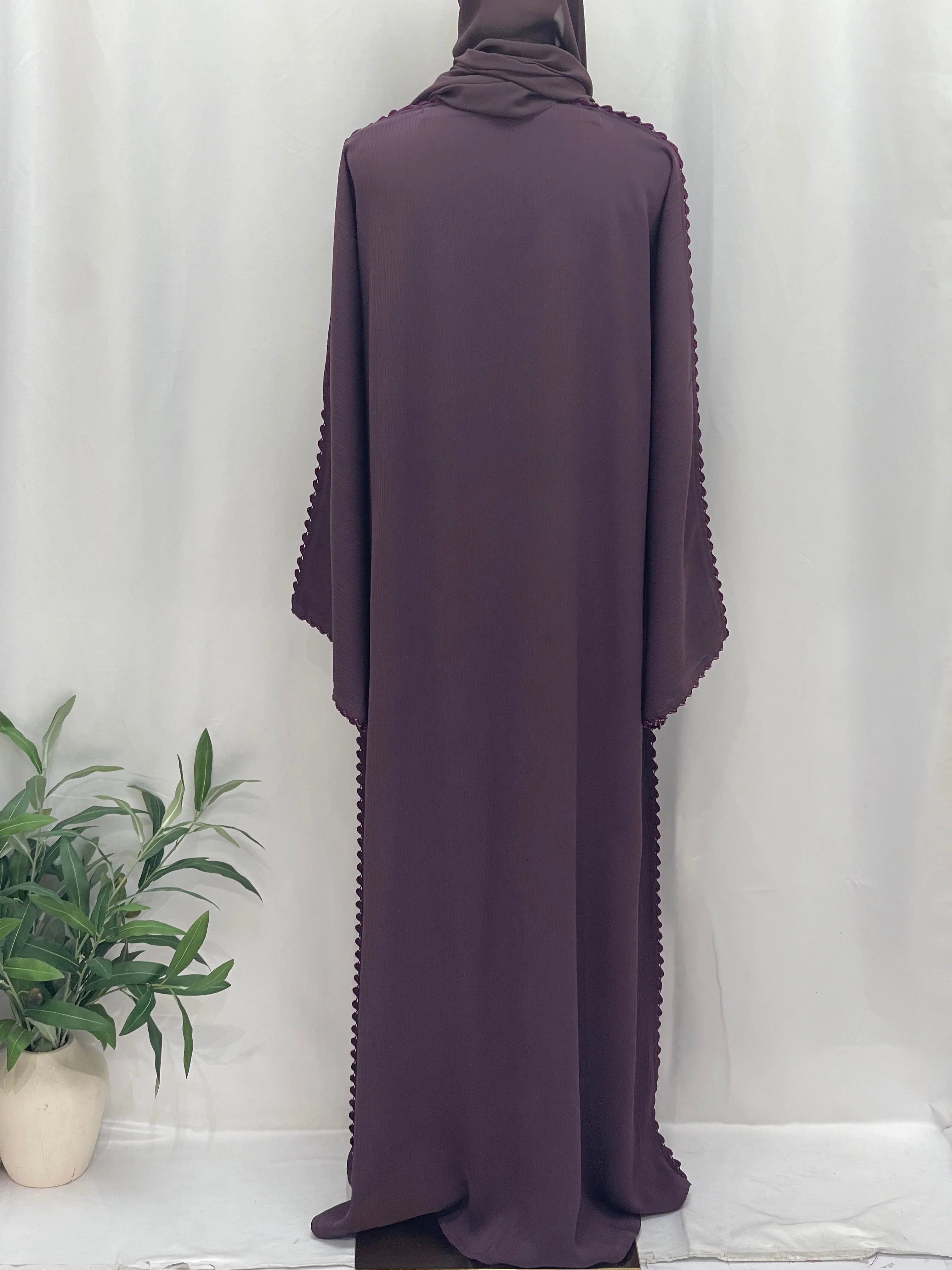 Back view of Palestinian Elegance Ghosoon Abaya in deep plum with scalloped edge detailing