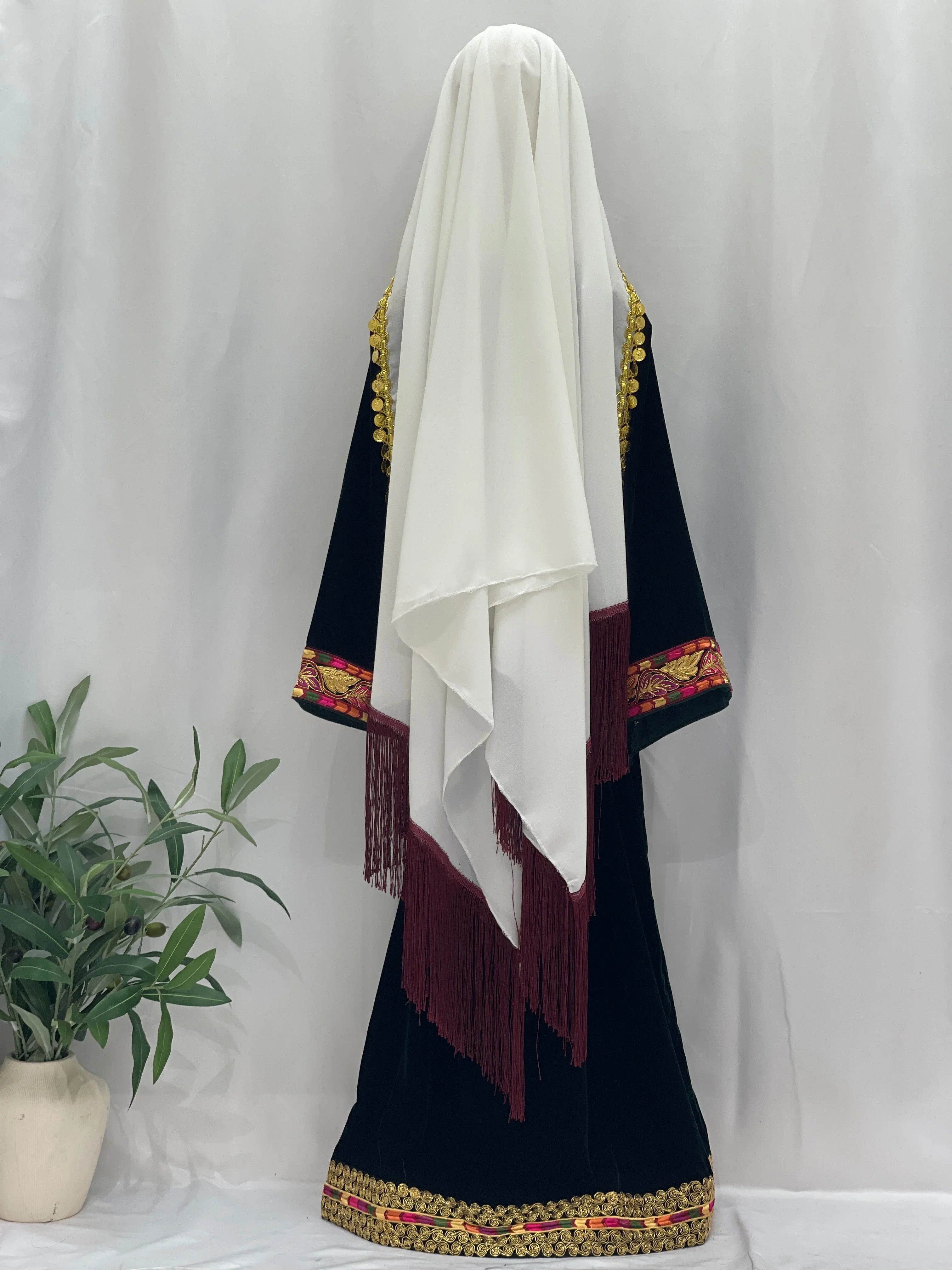 Emerald Velvet Embroidered Qasab Thobe with intricate details and a flowing white scarf