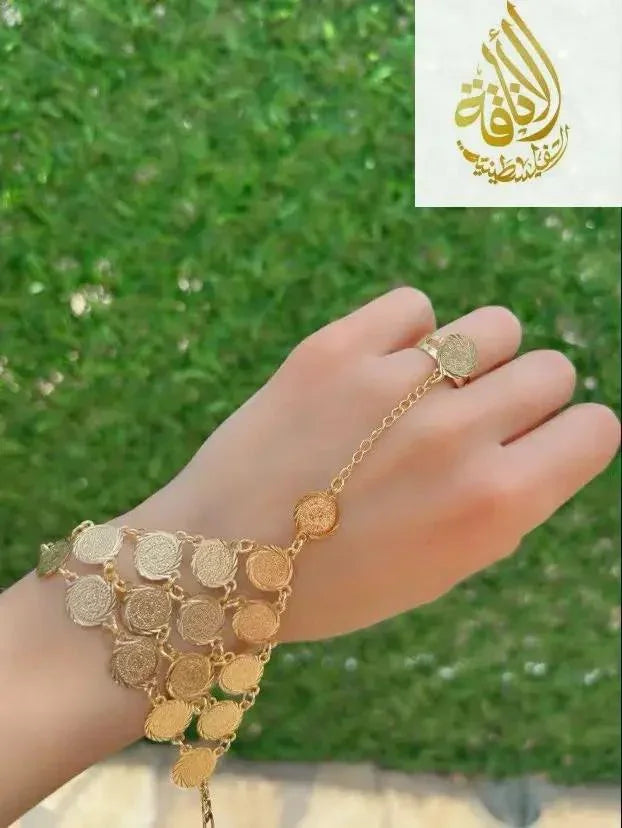 Gold kaff hand jewelry featuring intricate coin design on wrist and finger by Palestinian Elegance