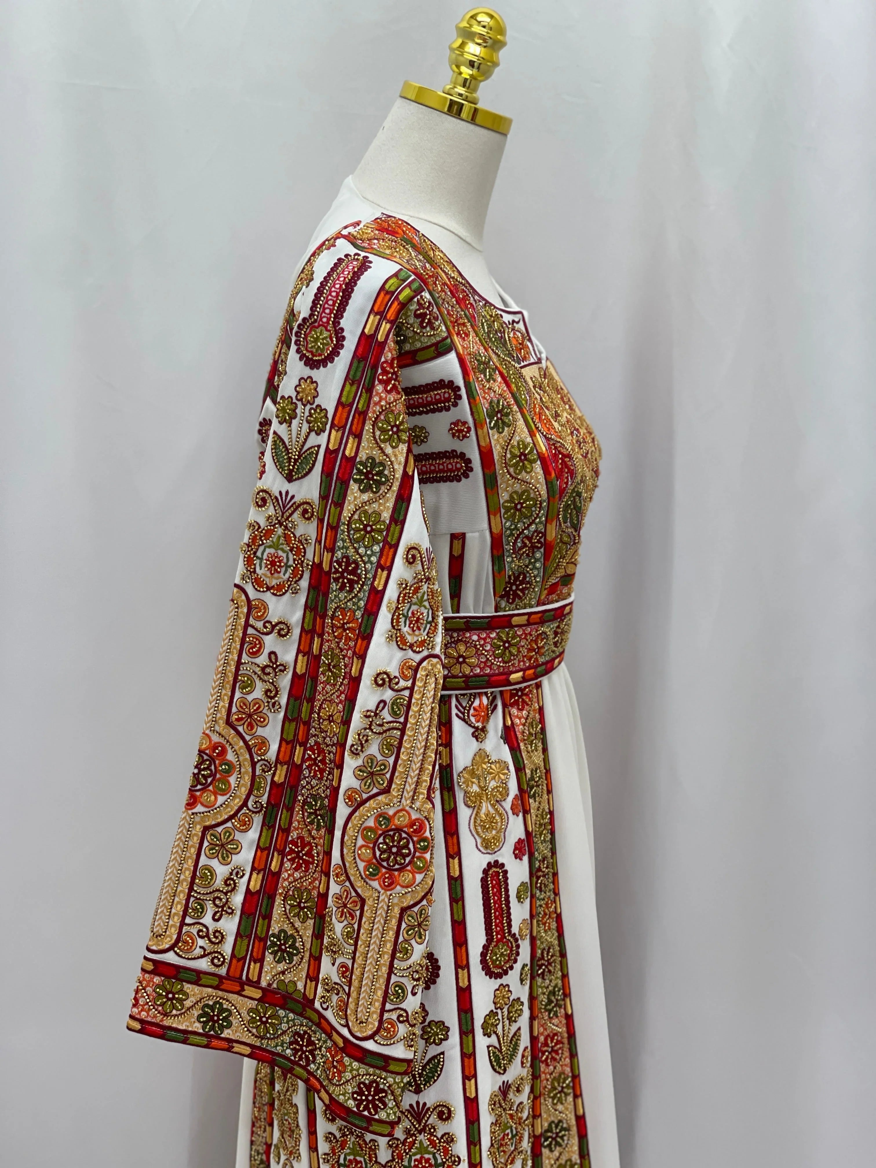 Golden Blossom Beaded Embroidered Thobe on mannequin side view white fabric with red and gold floral embroidery and matching belt