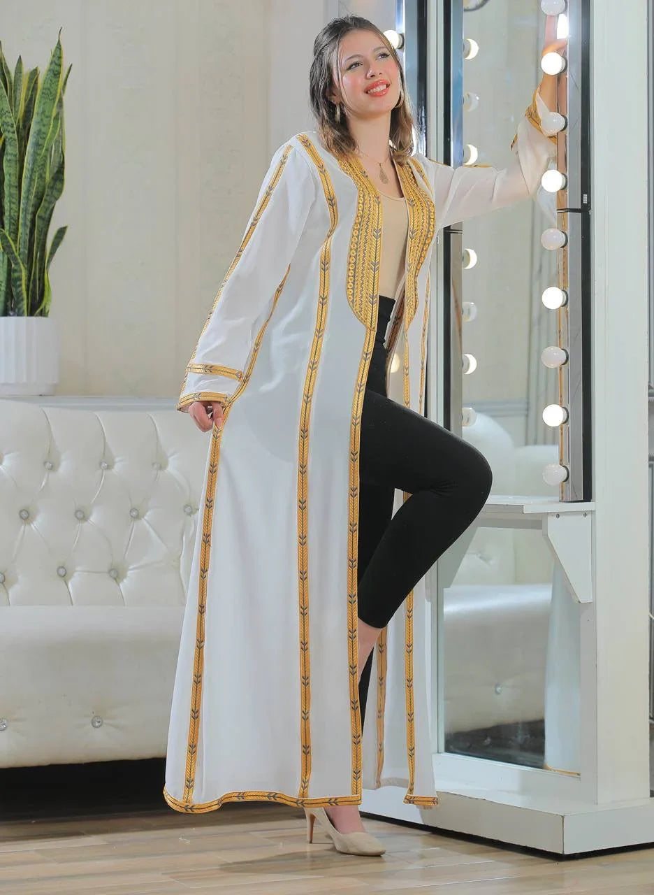 Palestinian Elegance Golden Touch Open Abaya white long cardigan with gold trim worn by model near vanity mirror