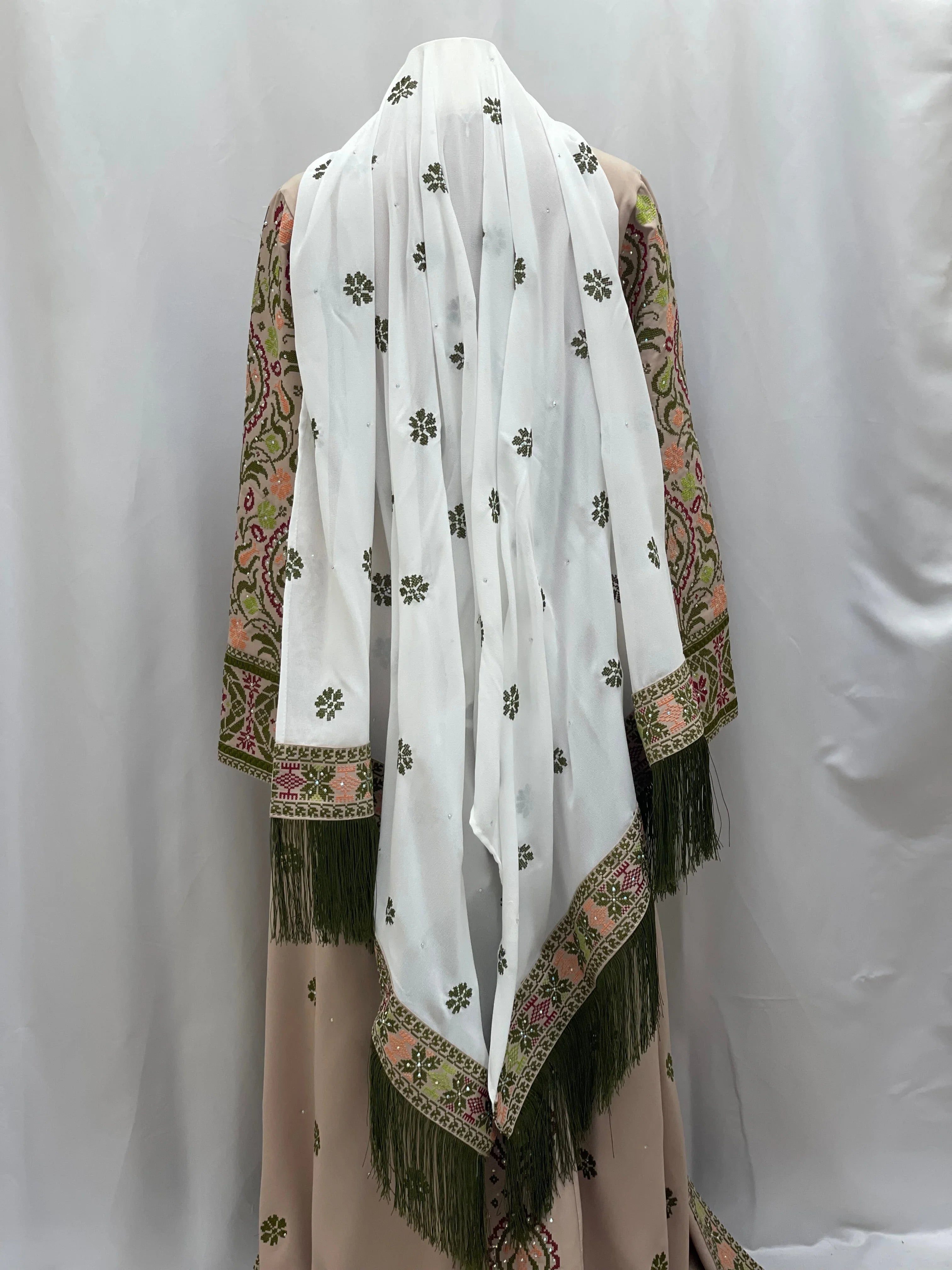 Back view of a Green Ruby Embroidered Thobe with decorative white scarf and intricate design details