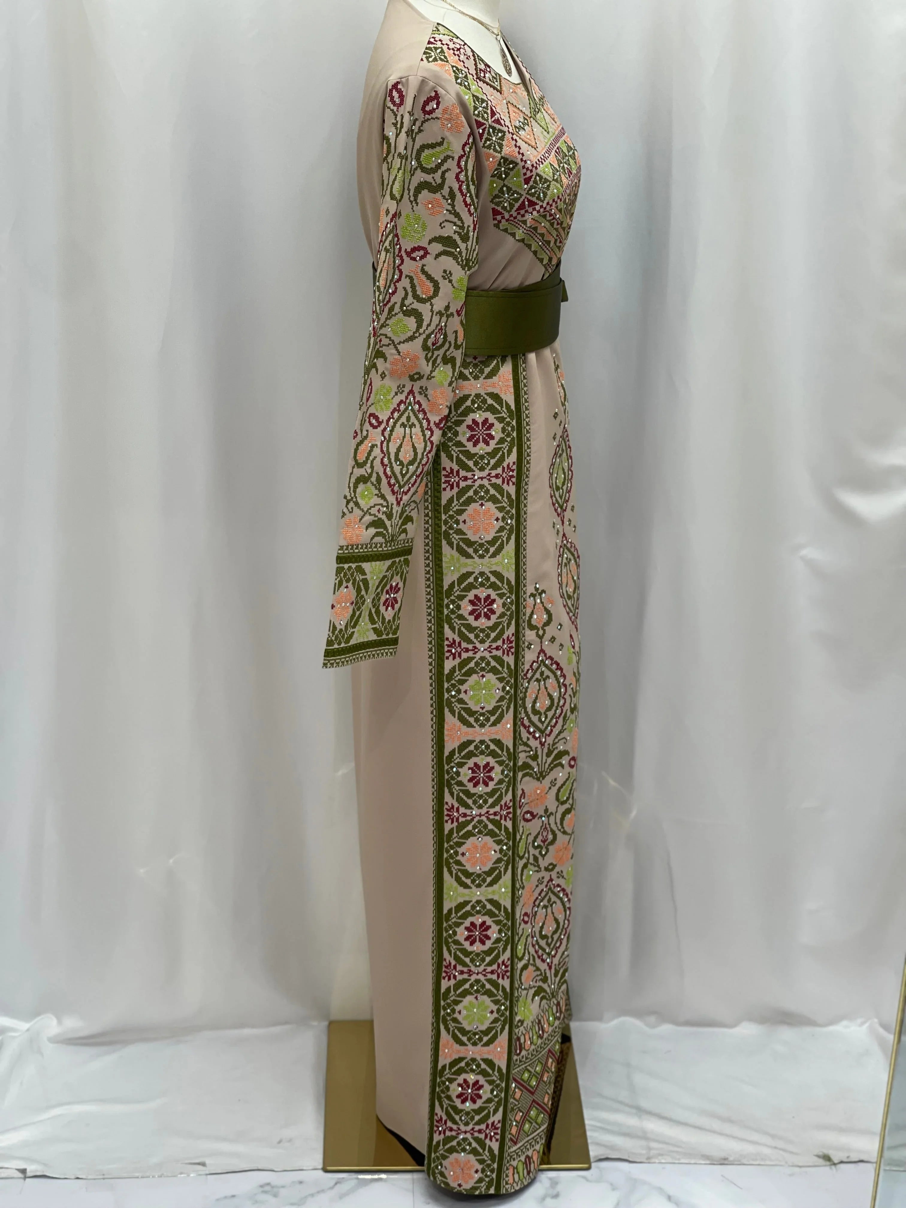 Green Ruby Embroidered Thobe featuring intricate floral designs and elegant belt detail