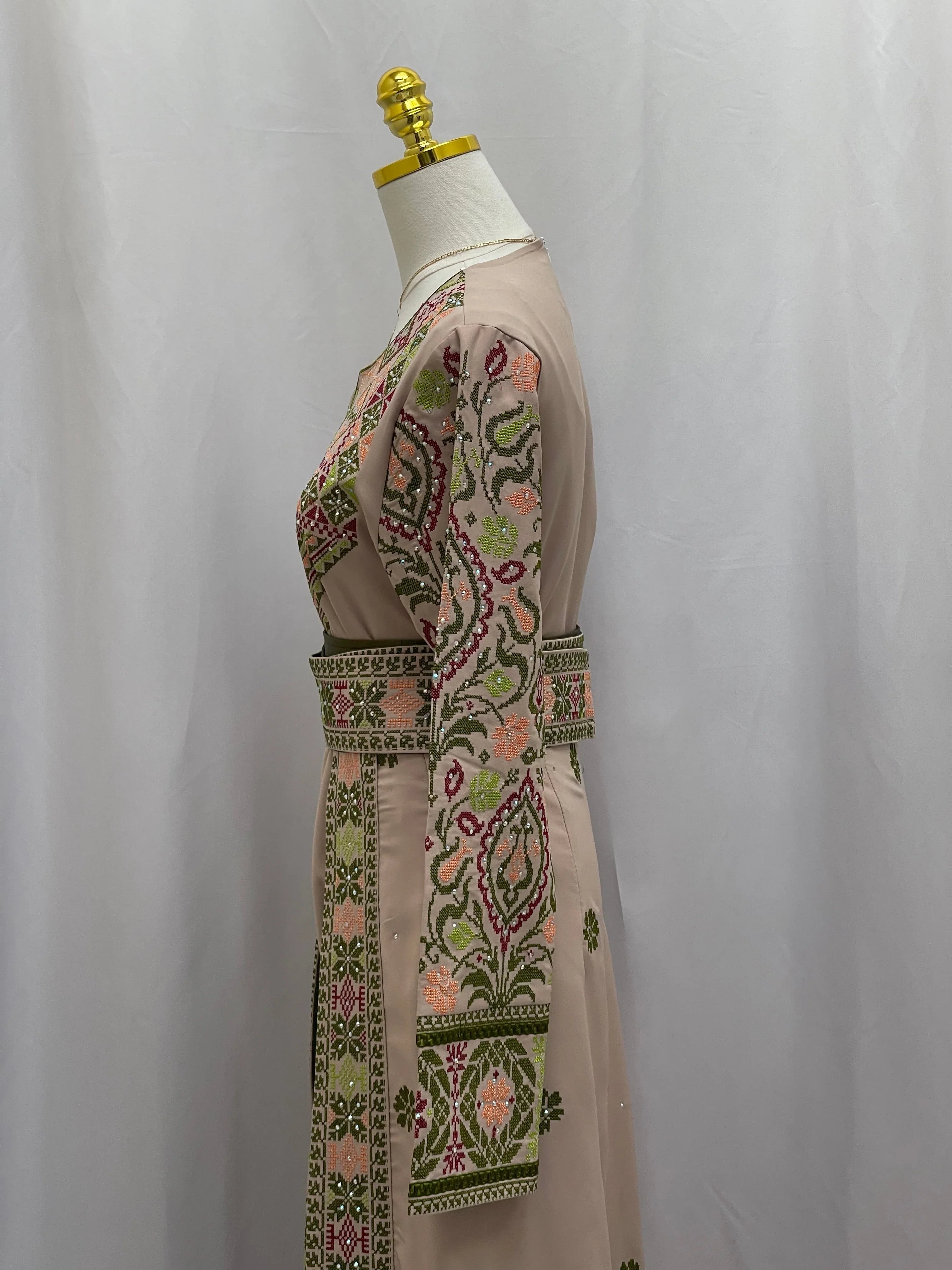 Side view of Green Ruby Embroidered Thobe with intricate floral embroidery and elegant design details