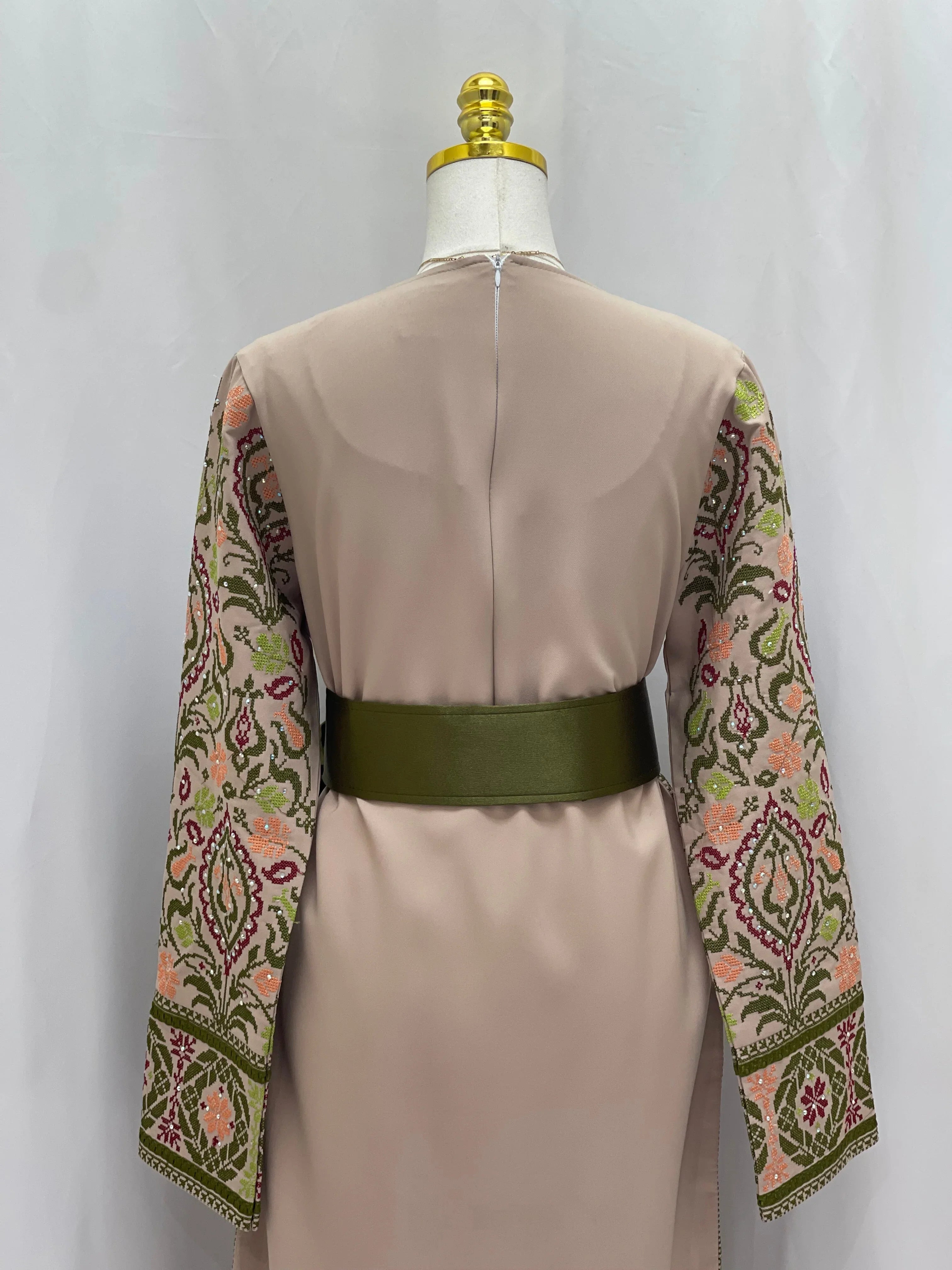 Back view of the Green Ruby Embroidered Thobe with intricate floral sleeve designs and a chic belt