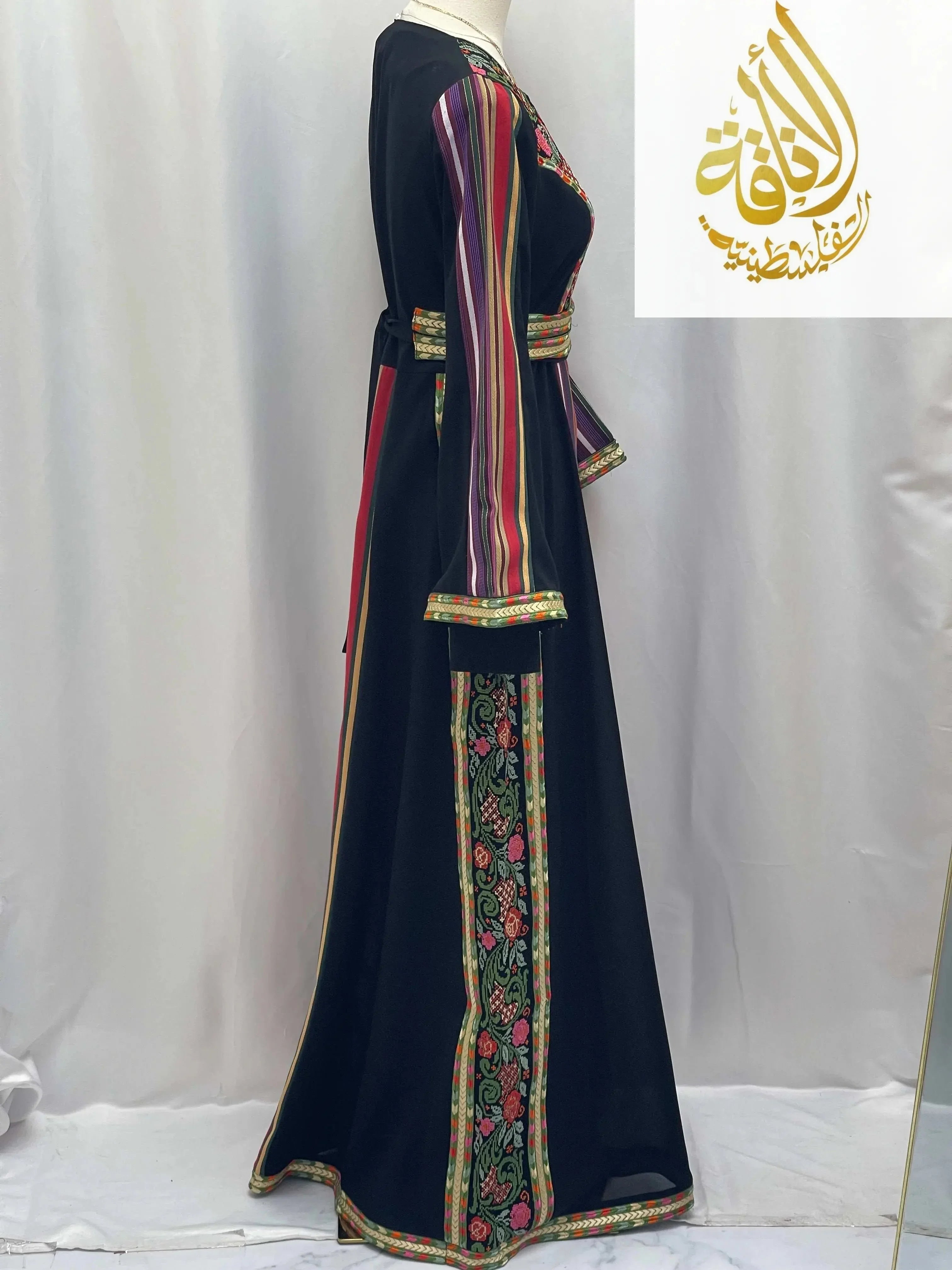 Side view of Haya Embroidered Majdalawe Dress Thoub by Palestinian Elegance with colorful striped and floral embroidery