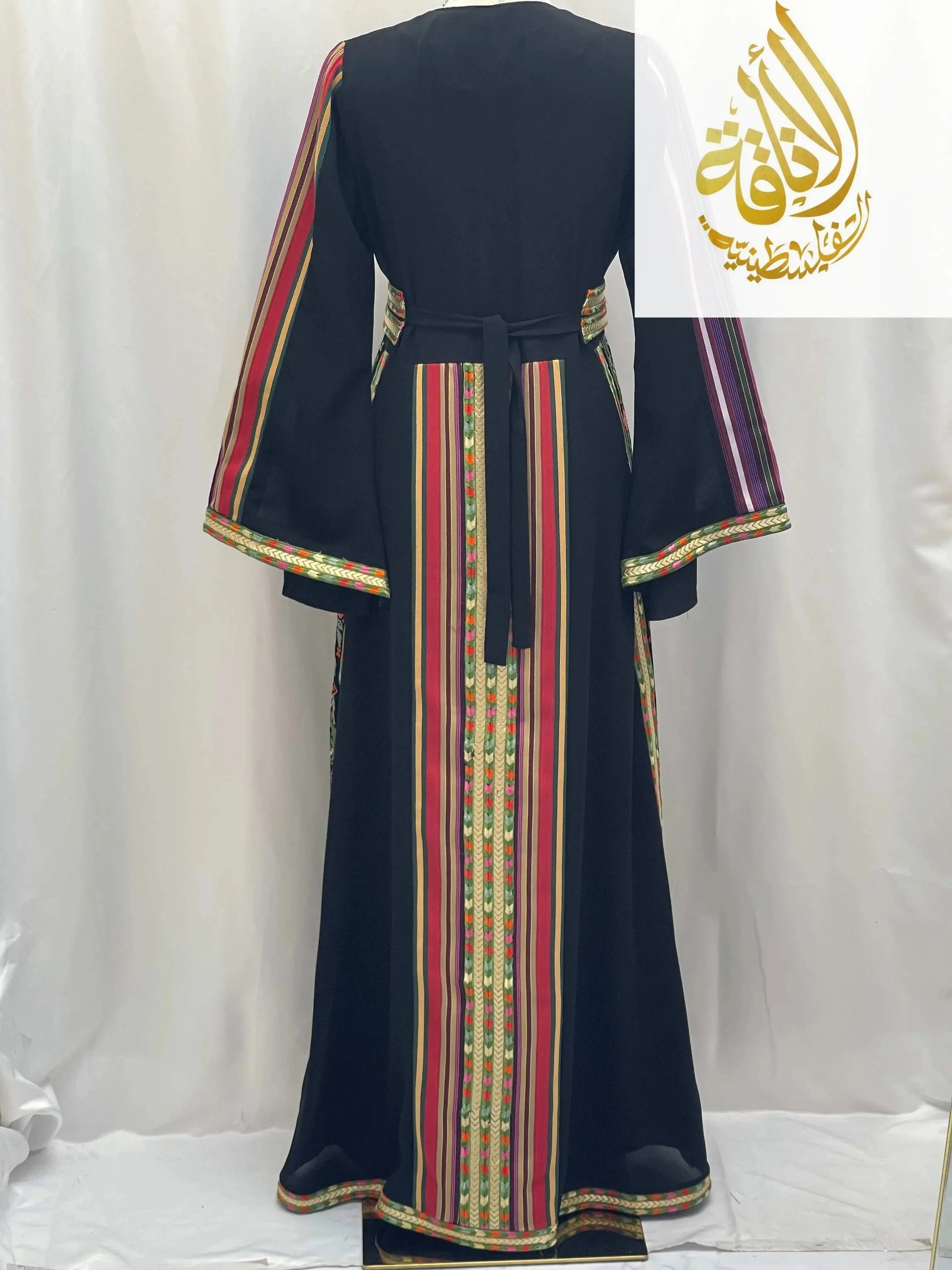 Back view of Haya Embroidered Majdalawe Dress thoub by Palestinian Elegance with colorful vertical stripes on black fabric