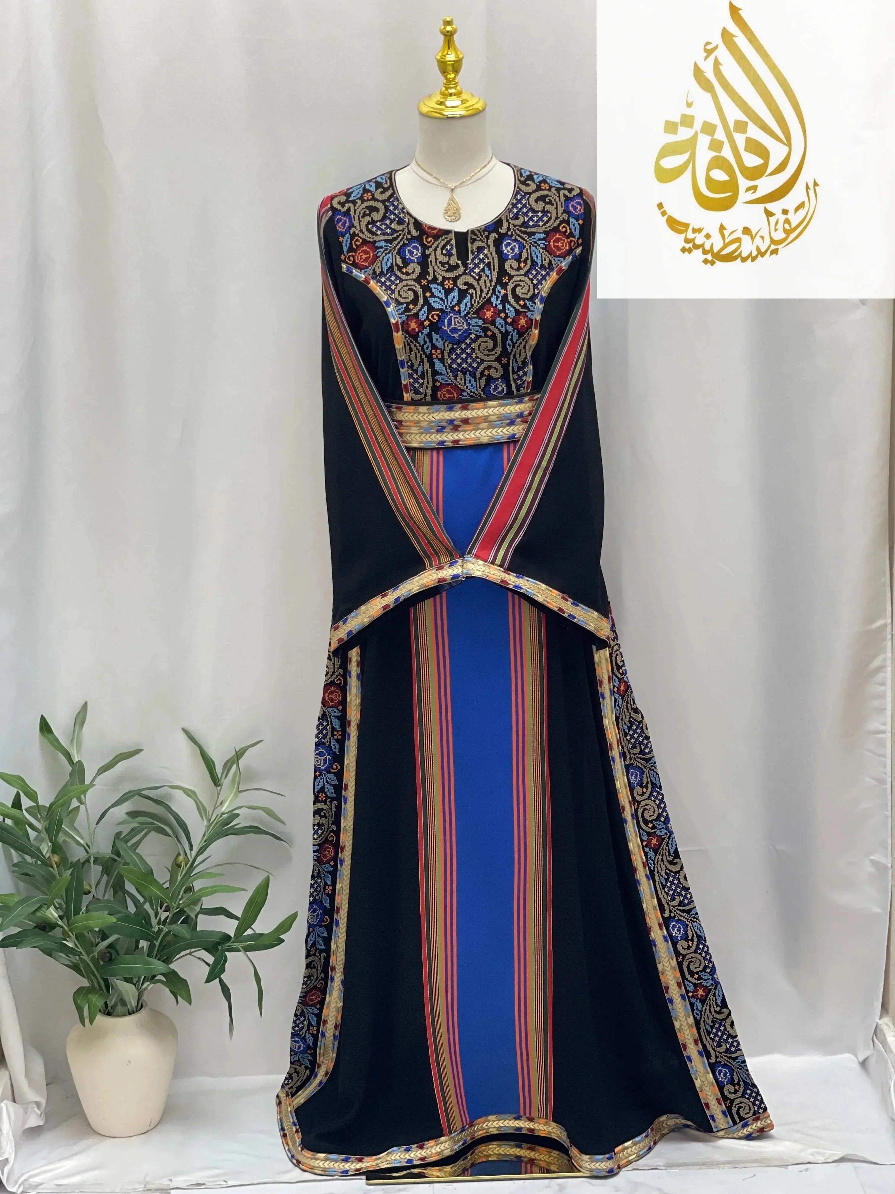 Haya Embroidered Majdalawe Dress by Palestinian Elegance with intricate embroidery and striped design