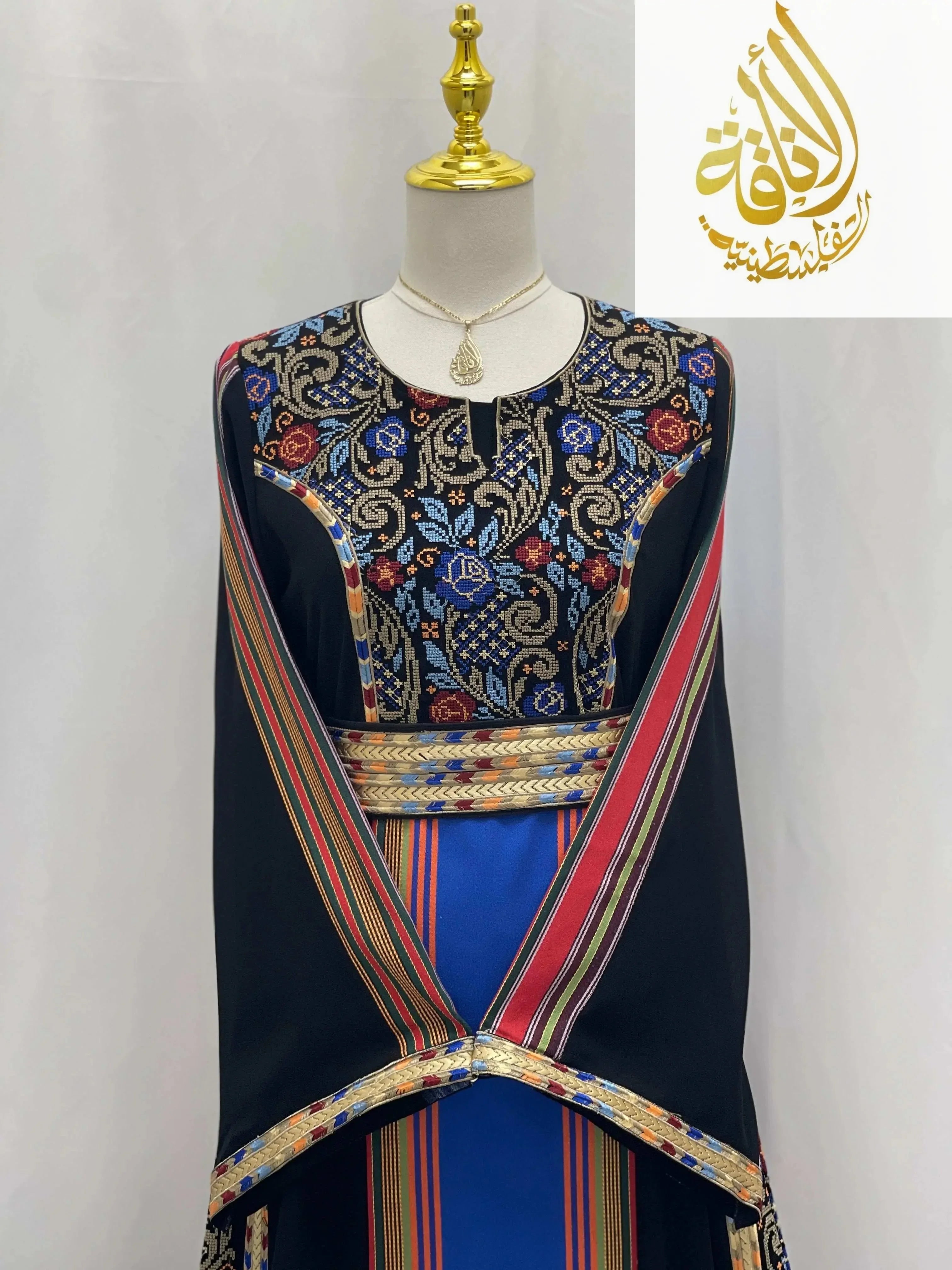 Haya Embroidered Majdalawe Dress thoub by Palestinian Elegance with intricate floral embroidery and colorful striped accents