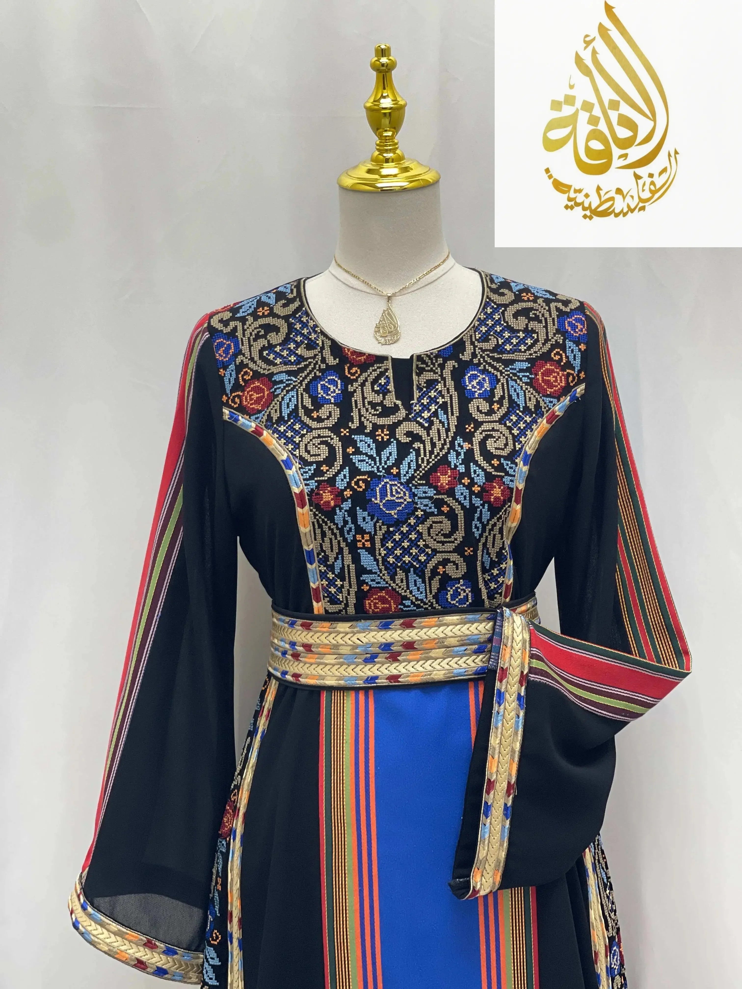 Haya Embroidered Majdalawe Dress by Palestinian Elegance featuring intricate floral embroidery and colorful striped patterns