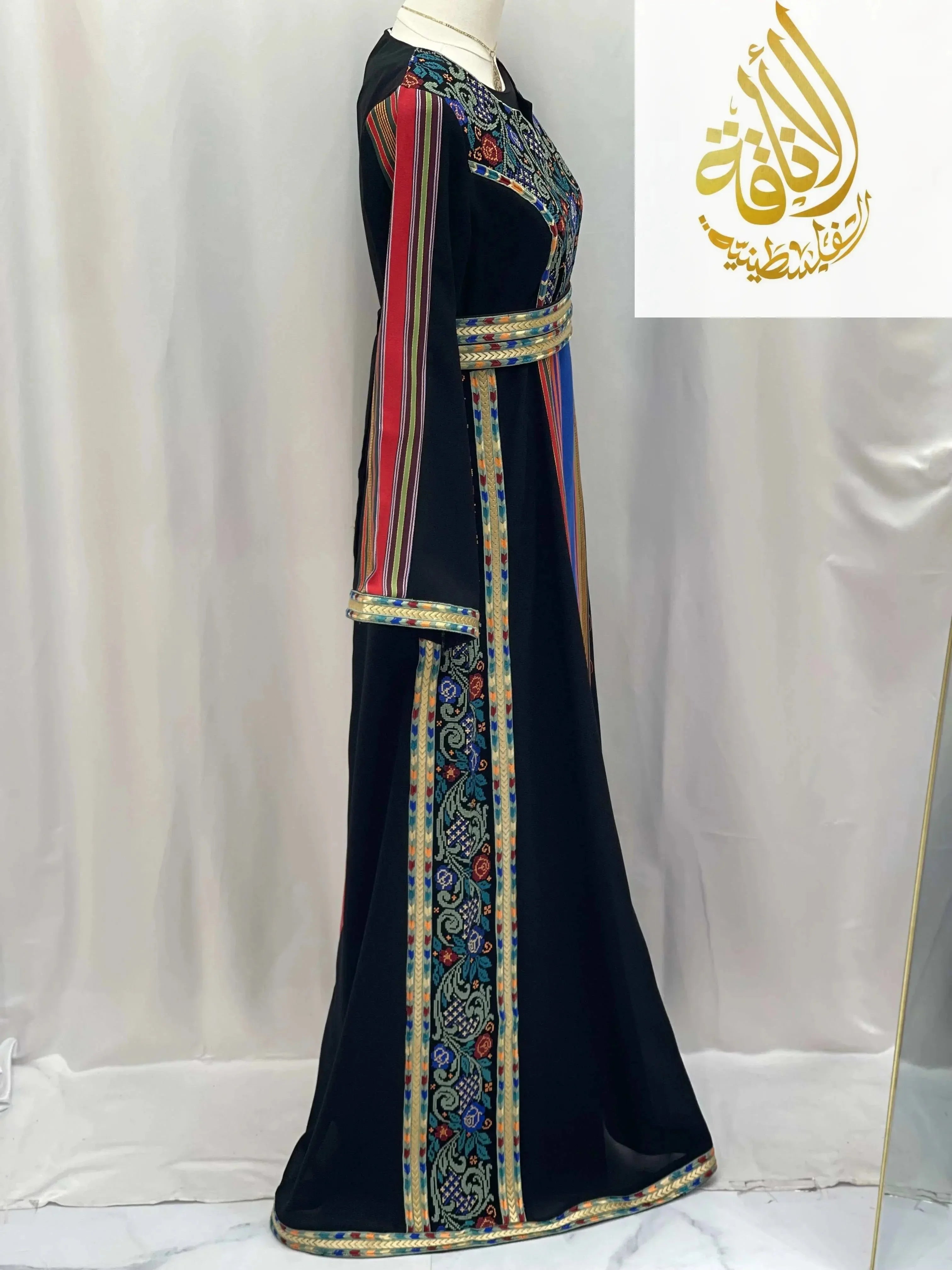 Side view of Haya Embroidered Majdalawe Dress thoub by Palestinian Elegance with colorful embroidery and striped sleeves