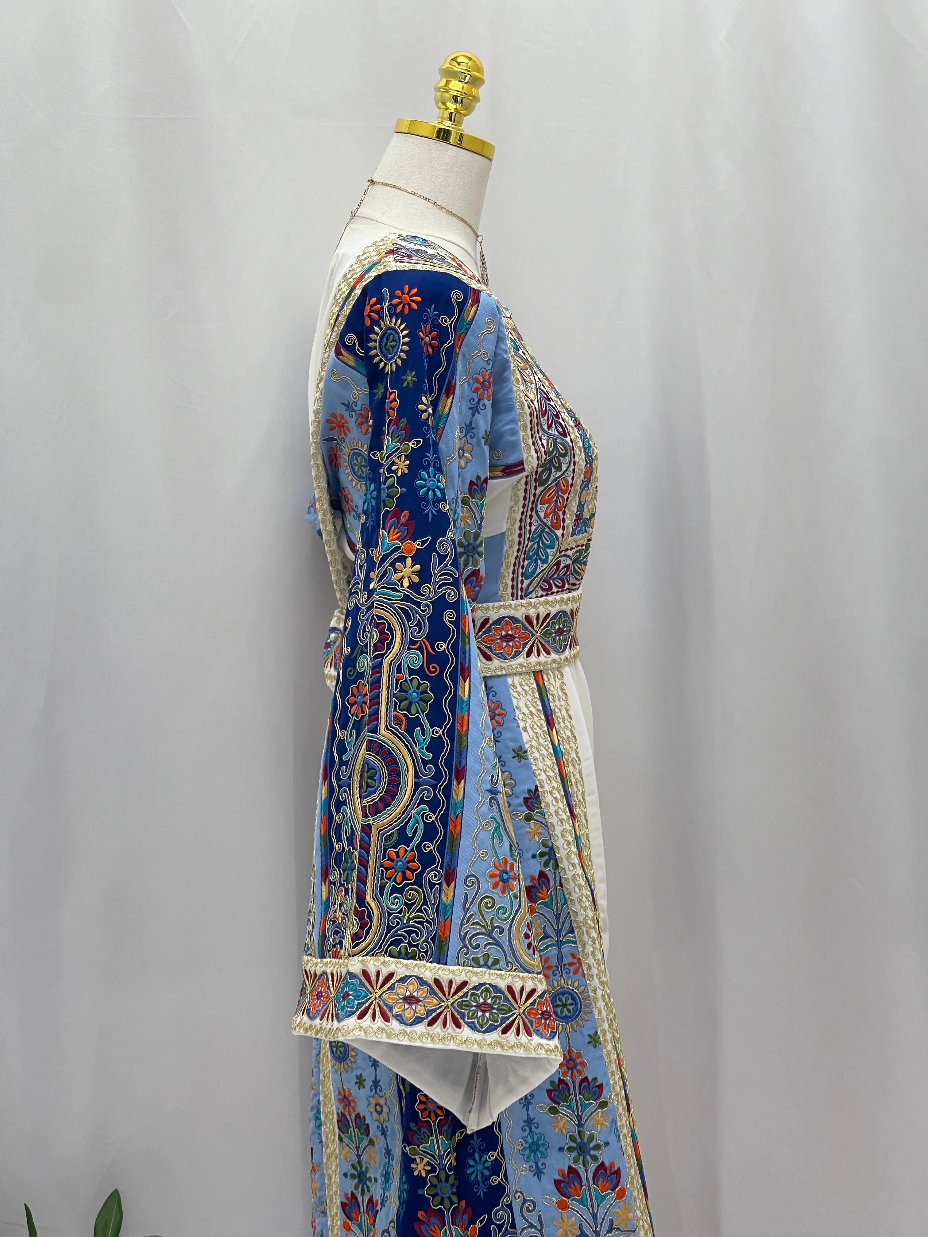 Heavenly Blossoms Thobe embroidered Palestinian Elegance side profile on mannequin blue floral paisley motifs