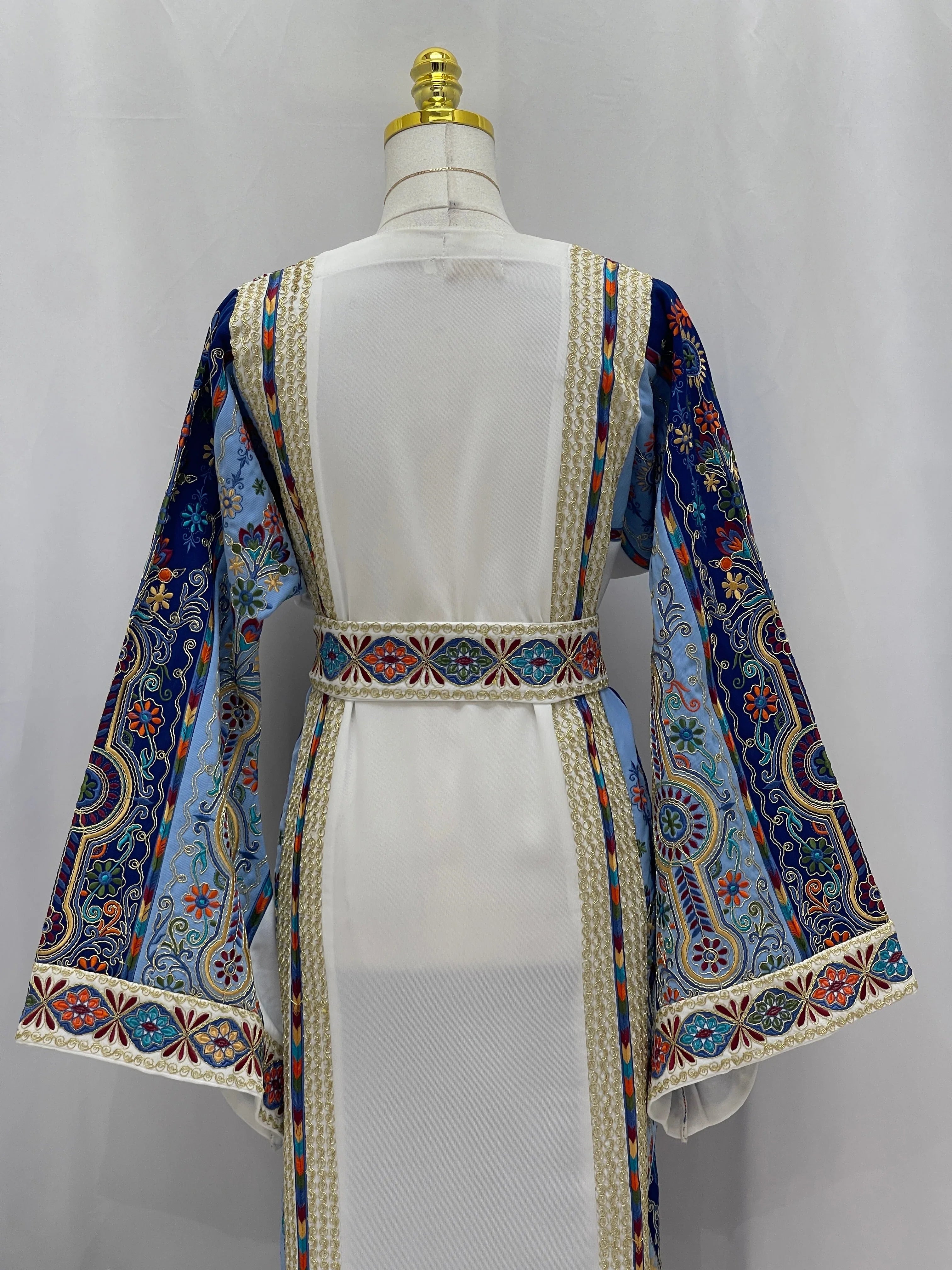 Heavenly Blossoms Thobe embroidered white thobe with colorful Palestinian blue floral sleeves and decorative waist belt back view
