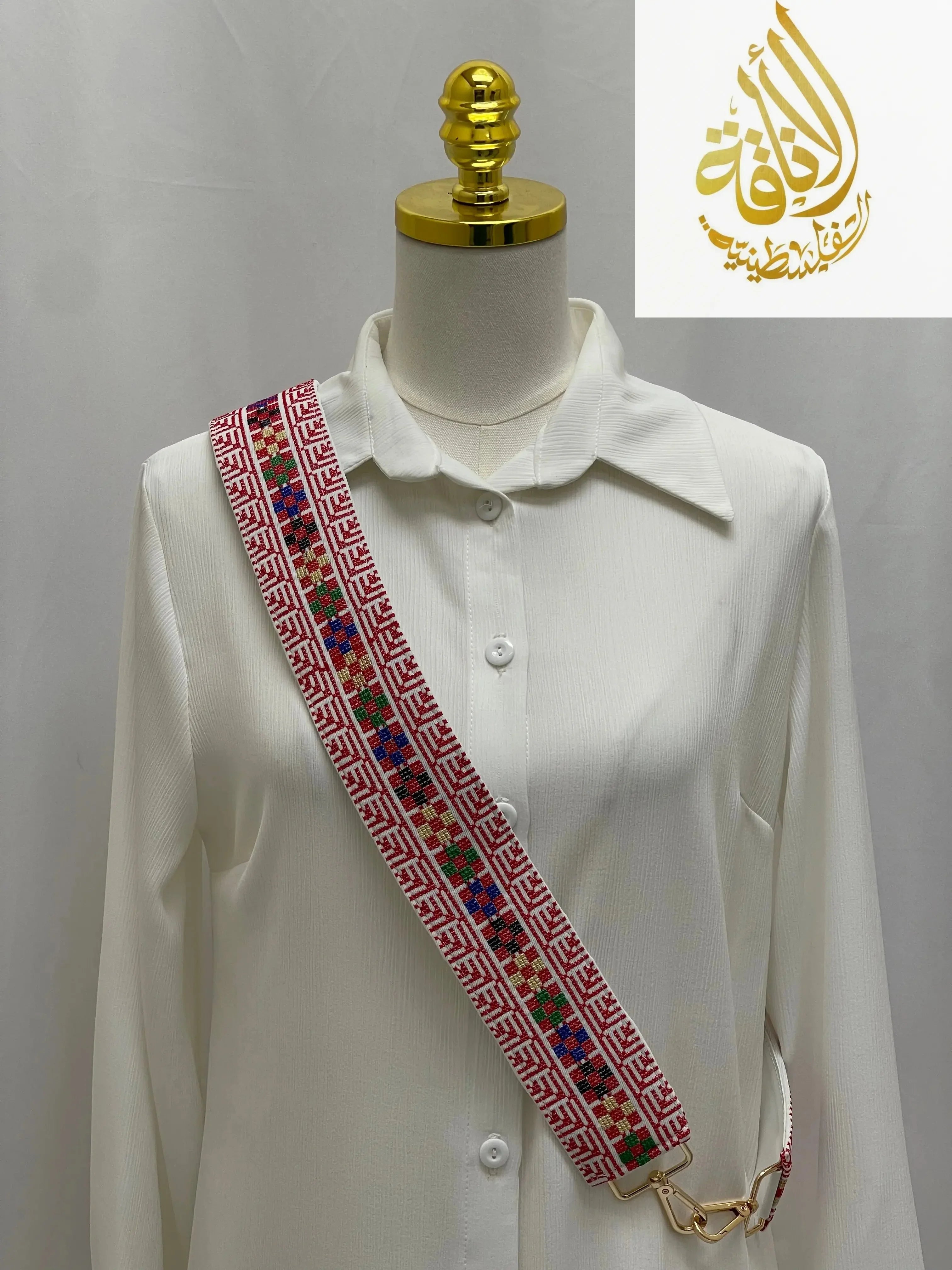 White shirt with a colorful embroidered collar on a mannequin against a white background