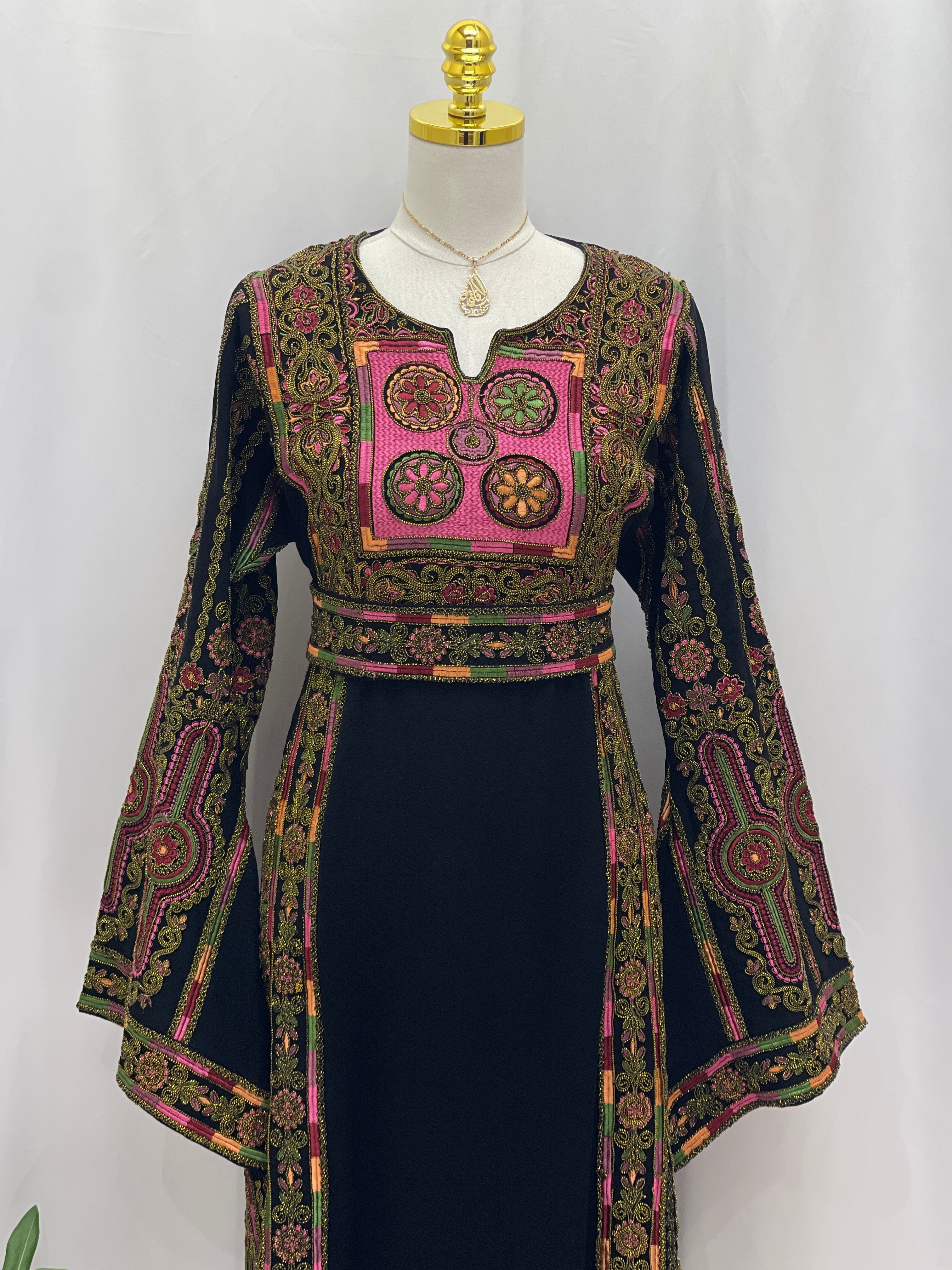Heritage Glow Bream Embroidered Thoub by Palestinian Elegance black thobe with pink and green chest embroidery and flared sleeves