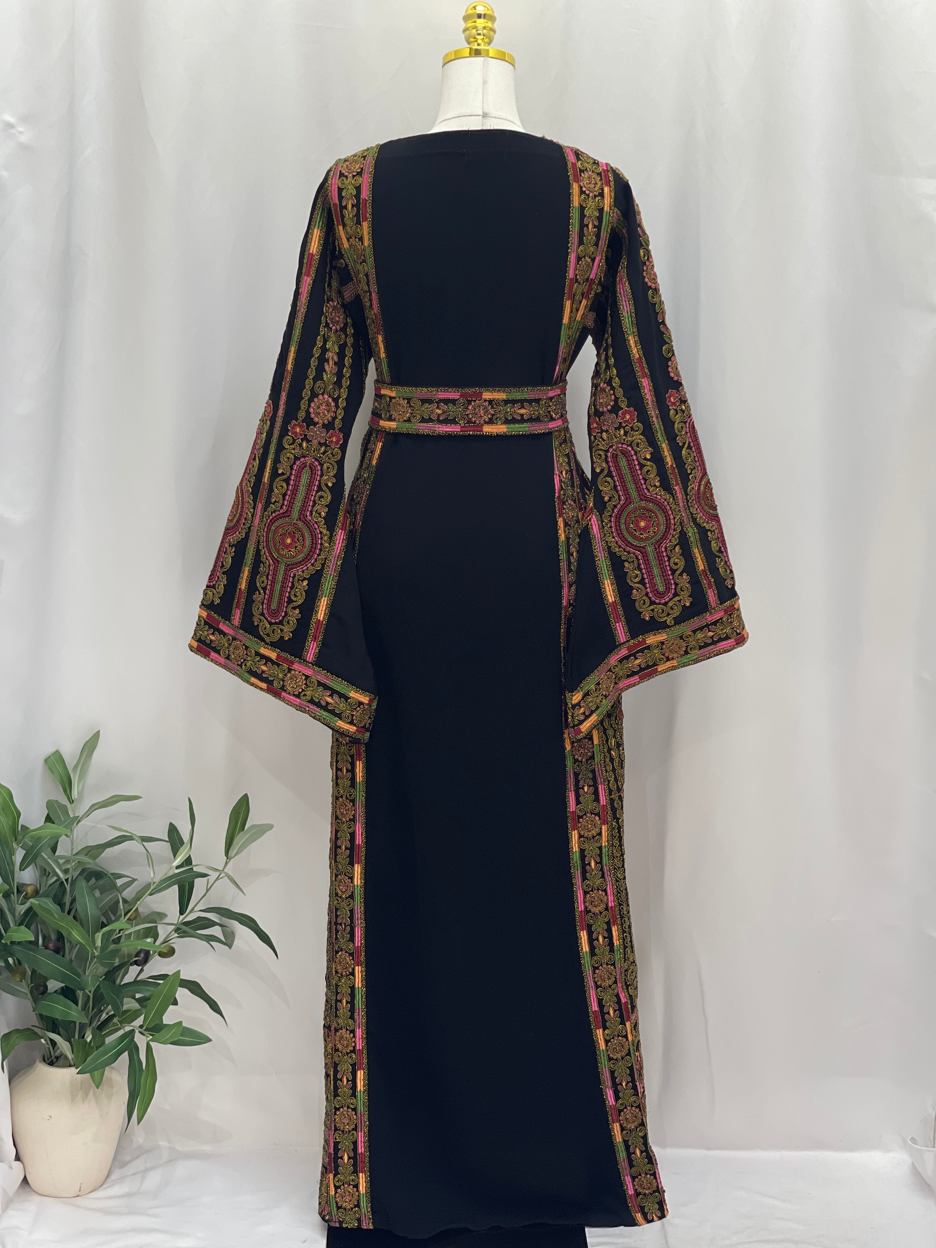 Heritage Glow Bream Embroidered Thoub by Palestinian Elegance black thoub back view with gold pink floral embroidery and belt