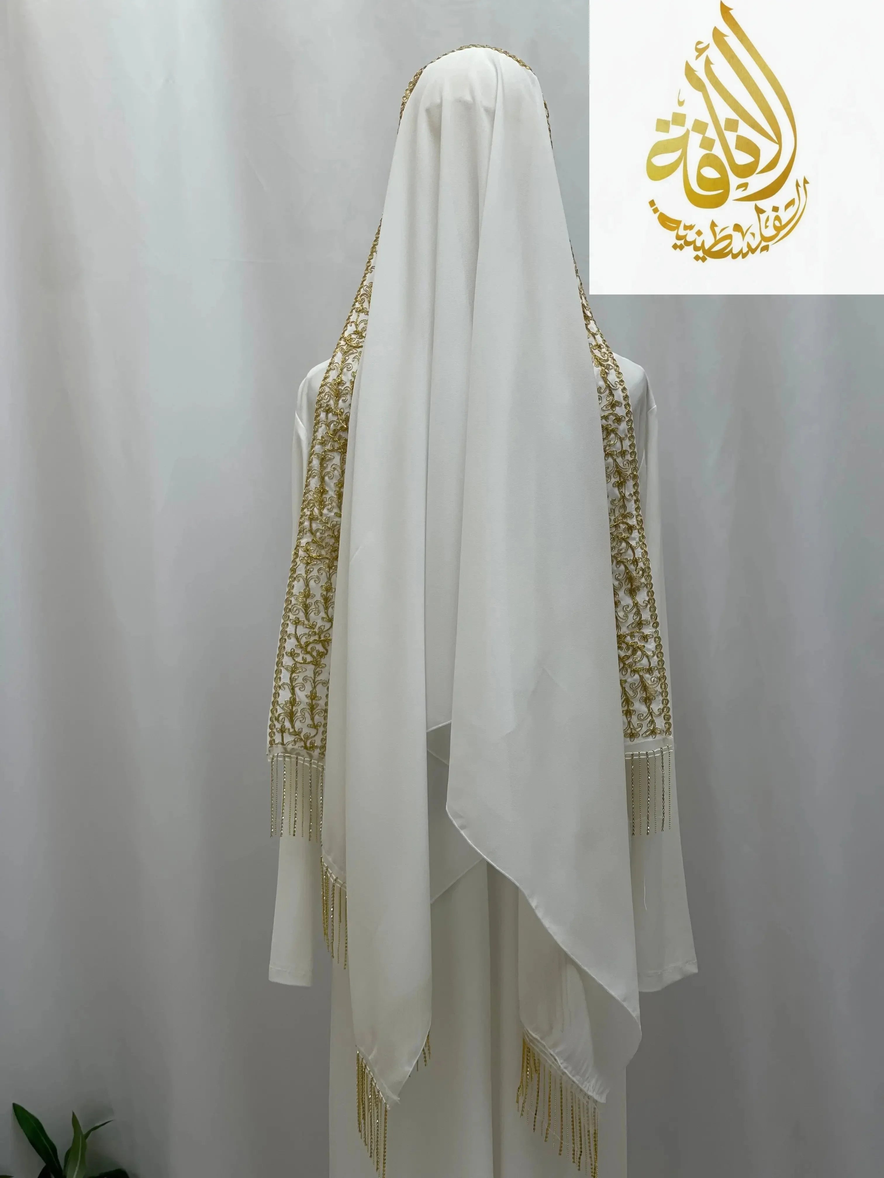 White embroidered Palestinian Traditional Modest Fashion Kasab Khirka with gold thread detailing from Palestinian Elegance