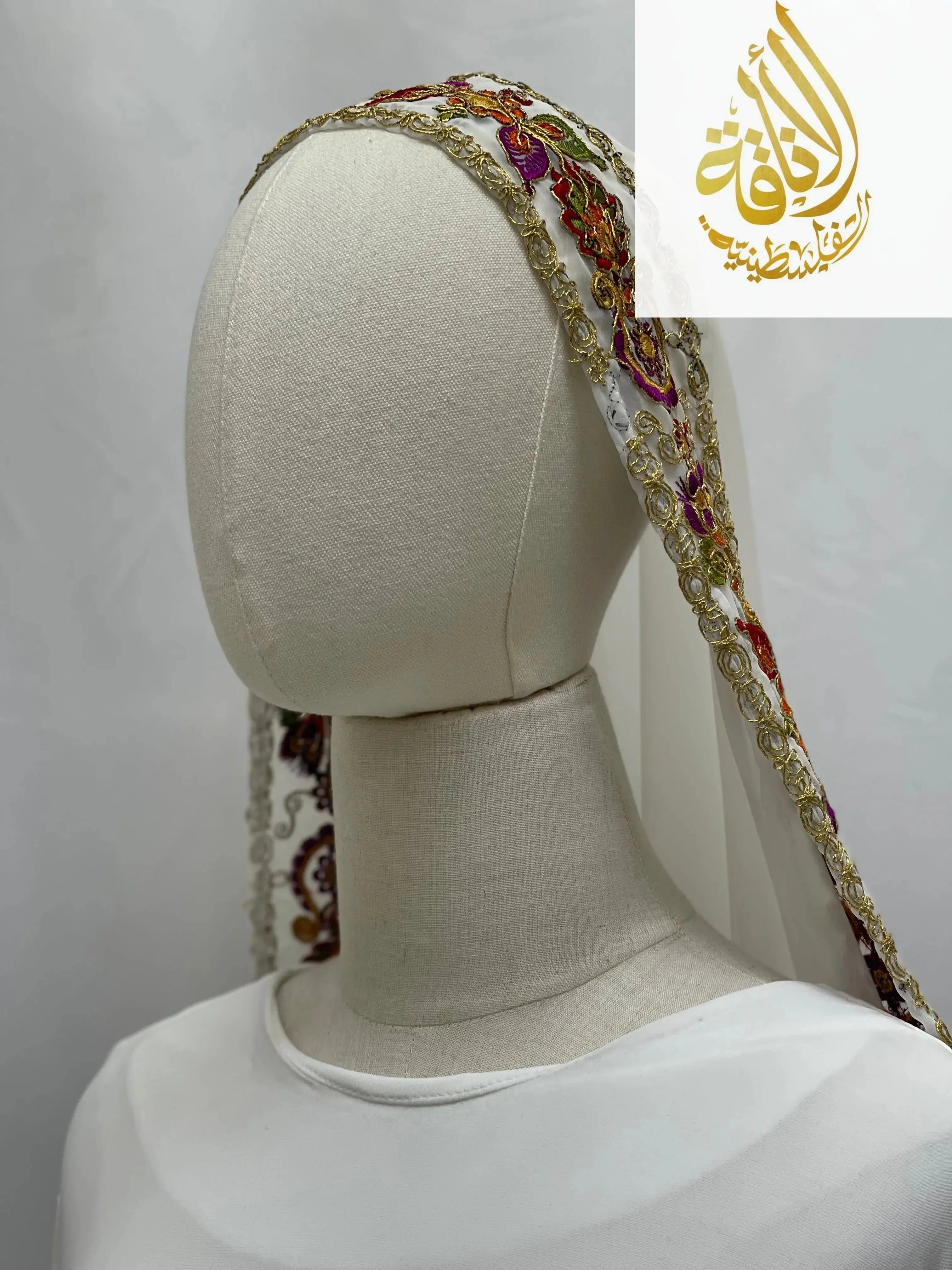 Palestinian Traditional Modest Fashion Kasab Khirka embroidered headscarf with colorful floral designs on white fabric