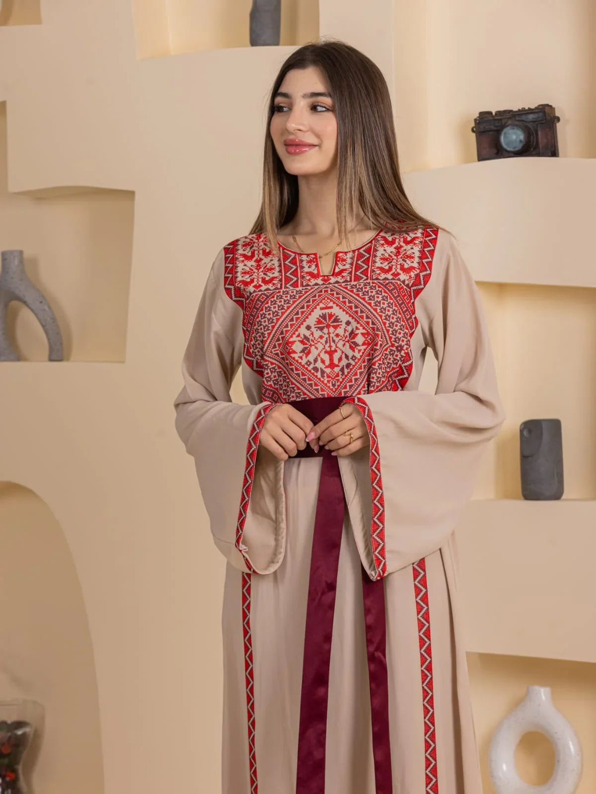 Huda Simply Embroidered Thoub beige Palestinian thobe with red cross stitch panel and burgundy ribbon belt