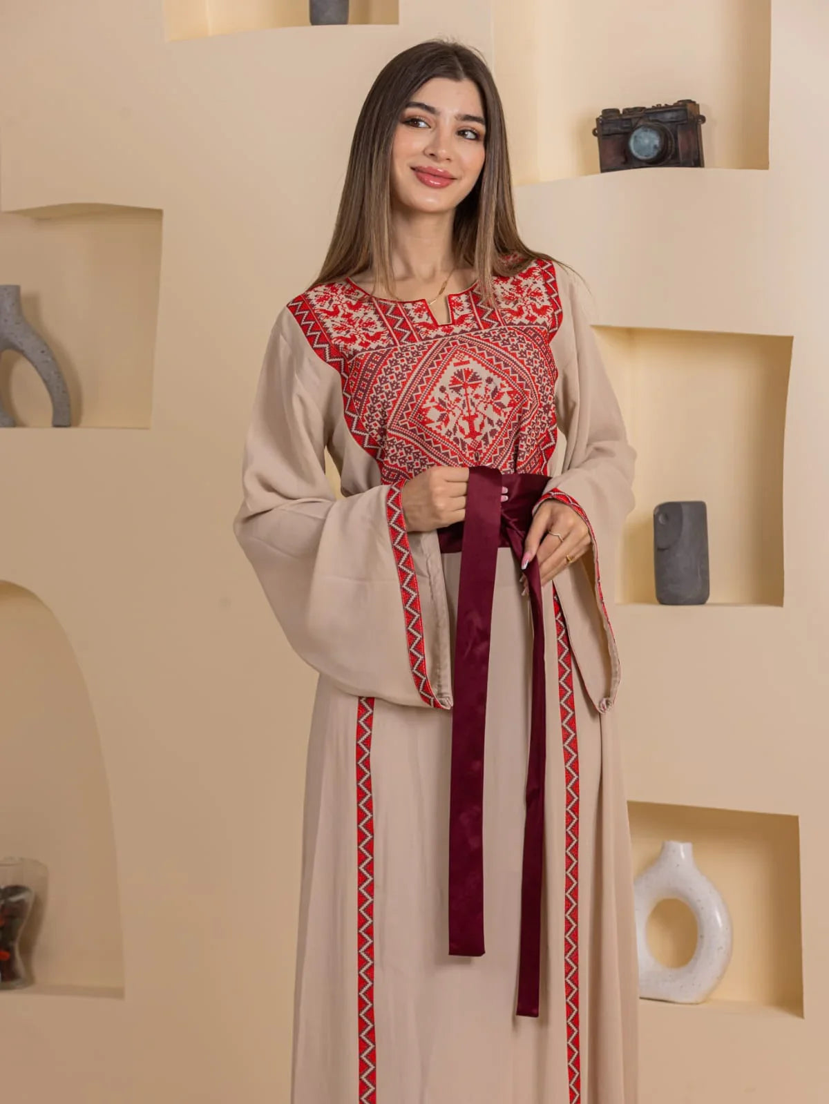 Huda Simply Embroidered Thoub beige Palestinian embroidered thobe with red geometric chest panel and burgundy waist tie