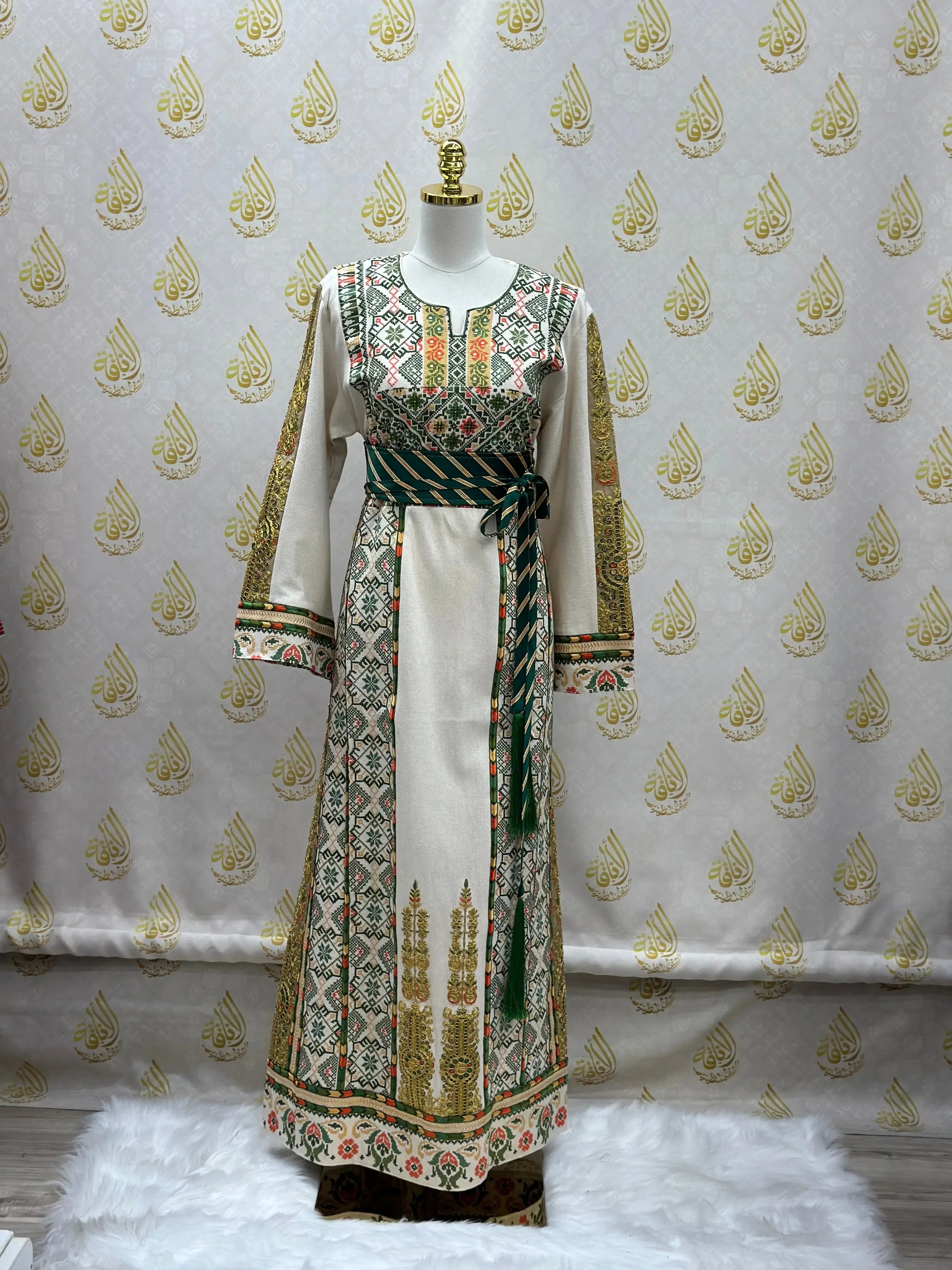 Embroidered Palestinian thobe with intricate traditional patterns and green waist tie from Palestinian Elegance