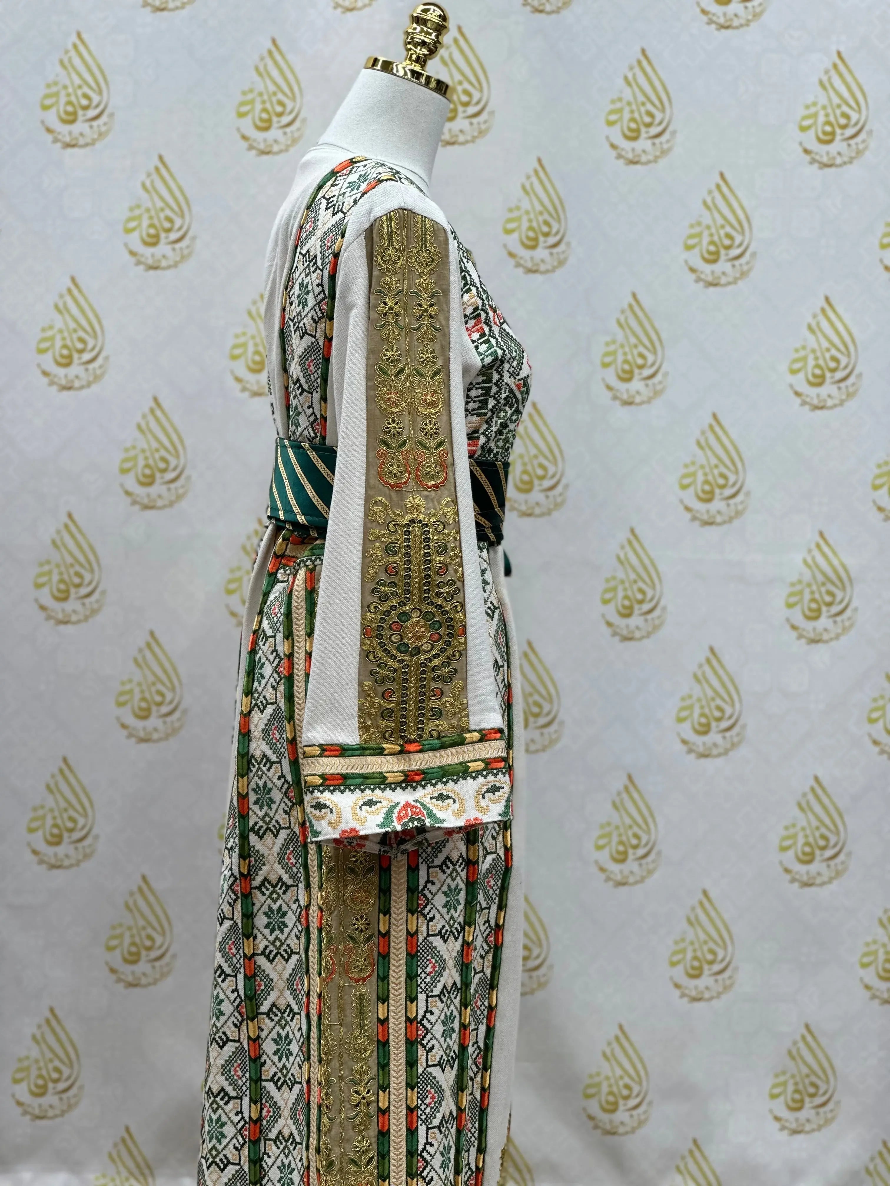 Embroidered Palestinian thobe with intricate traditional patterns displayed on a mannequin by Palestinian Elegance