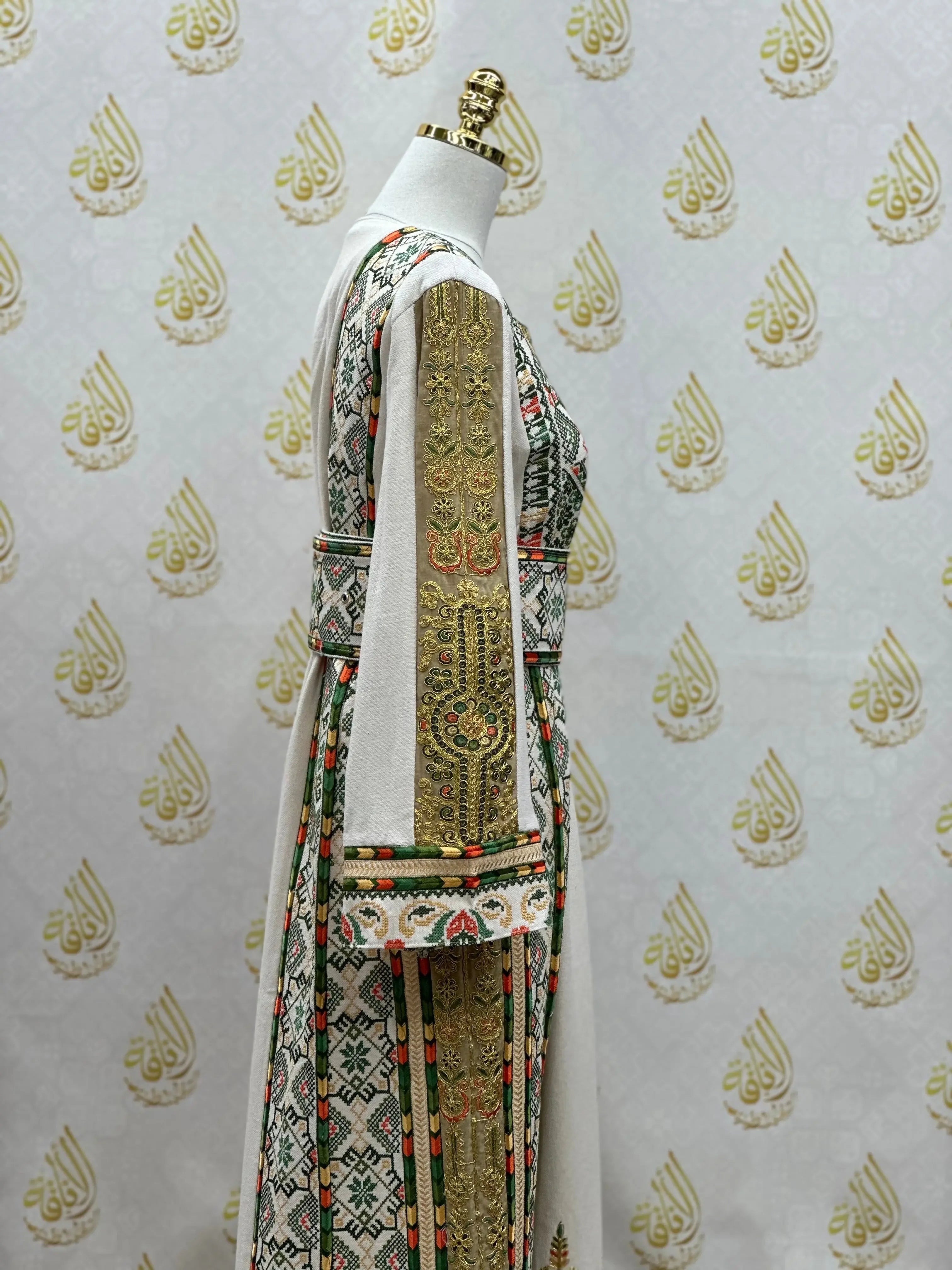 Side view of embroidered Palestinian thobe with intricate gold and multicolor traditional designs by Palestinian Elegance