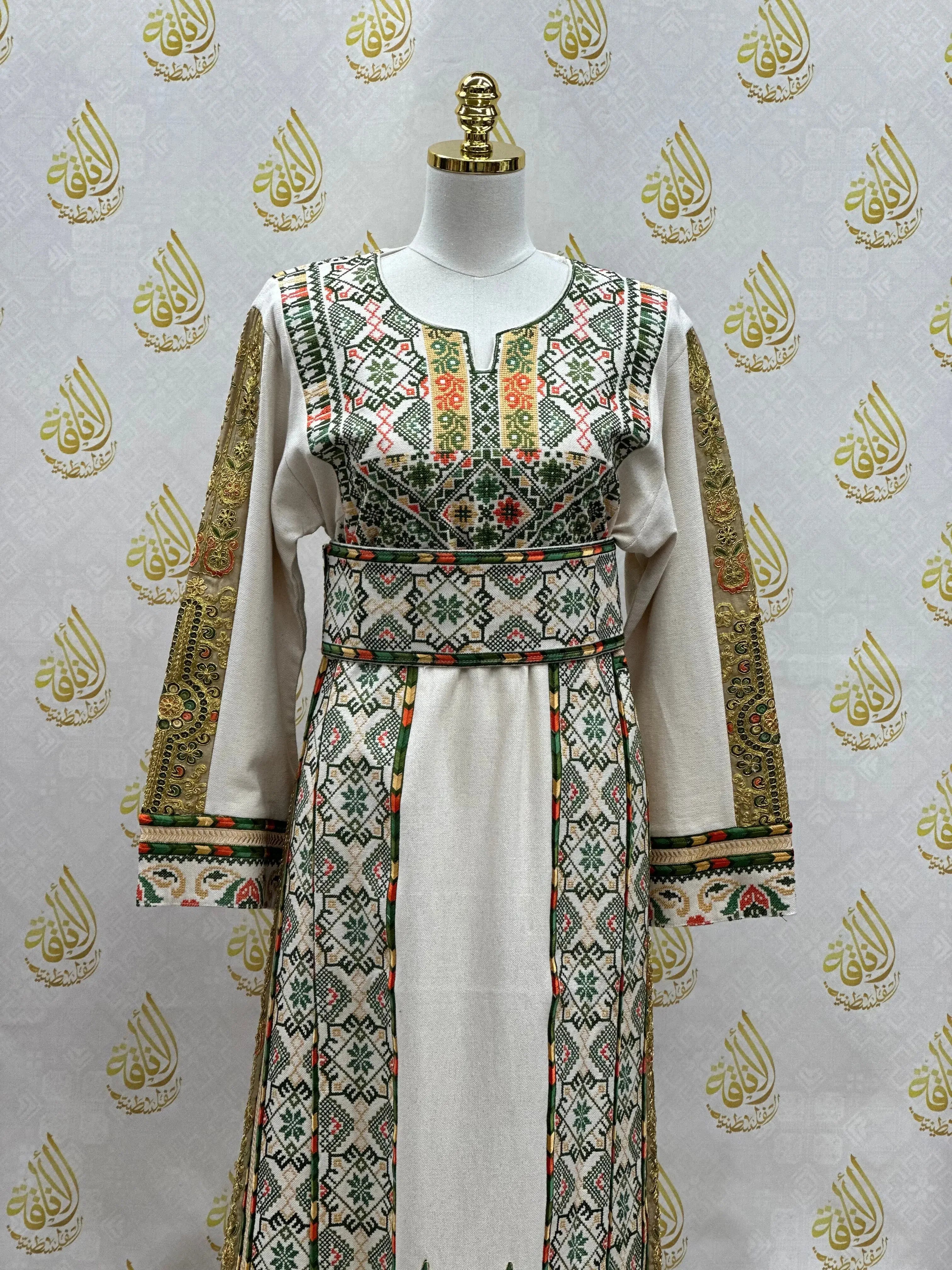 Embroidered Palestinian thobe with intricate geometric and floral designs in green, red, and gold