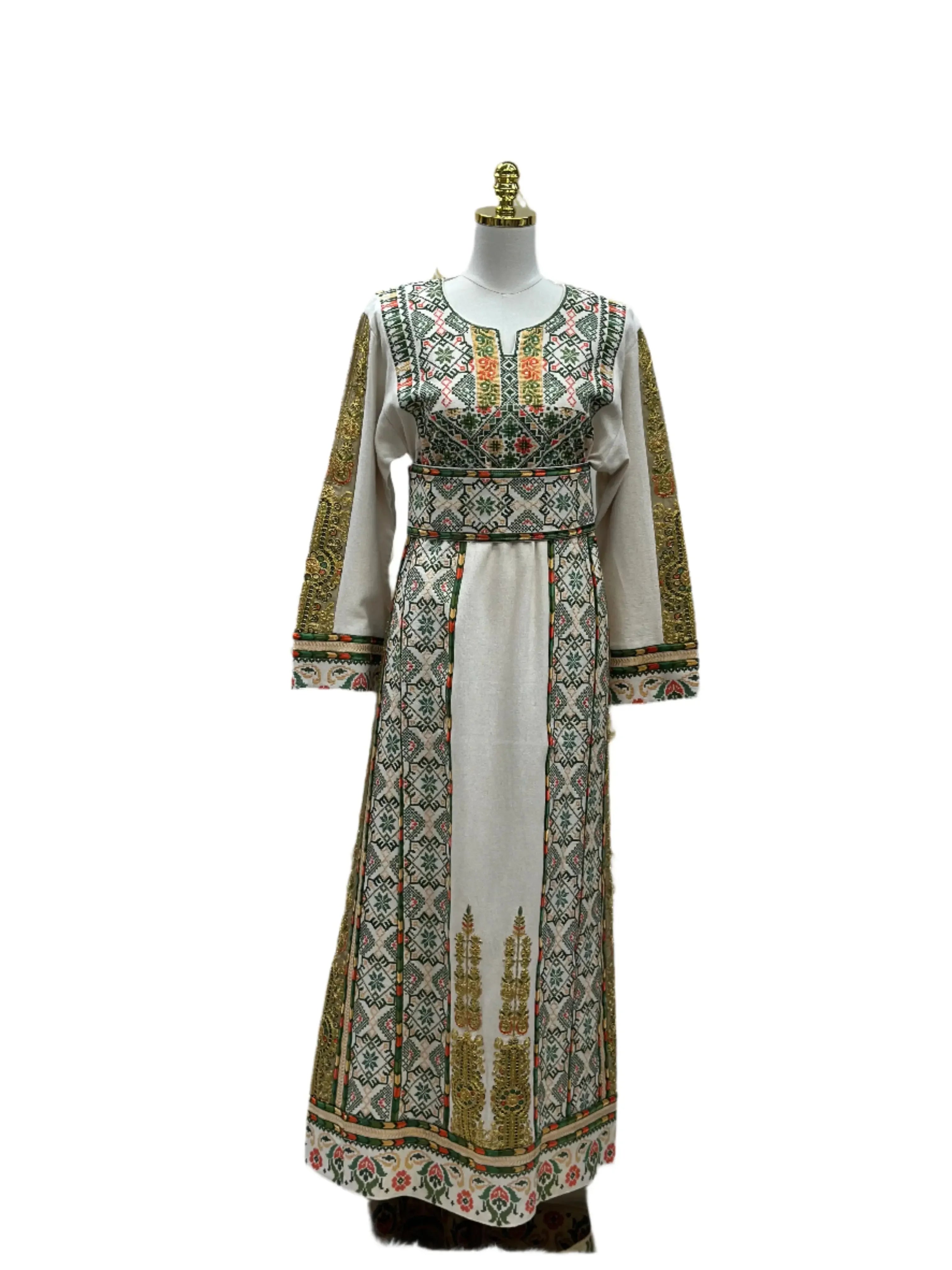 Embroidered Palestinian thobe with intricate green and gold traditional embroidery on white fabric
