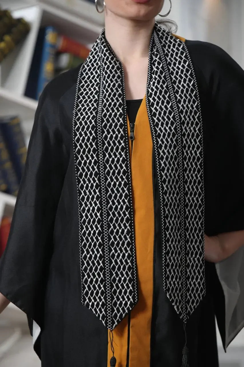 Palestinian keffiyeh graduation stole worn over black and yellow outfit by Palestinian Elegance