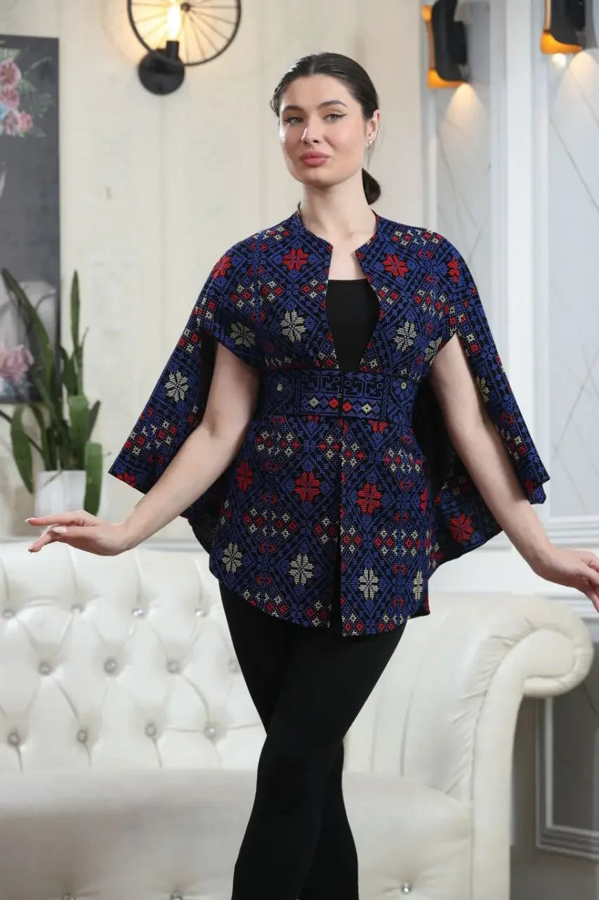 Palestinian tattreez cape by Palestinian Elegance featuring traditional embroidery in red and blue