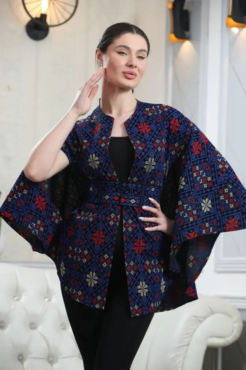 Palestinian tattreez cape by Palestinian Elegance in blue with red and white embroidered patterns