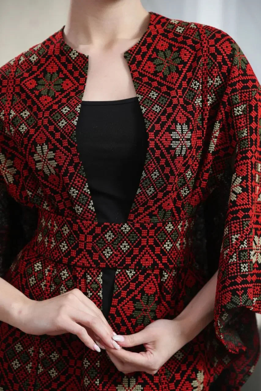 Palestinian tattreez cape by Palestinian Elegance featuring traditional red and black embroidery details