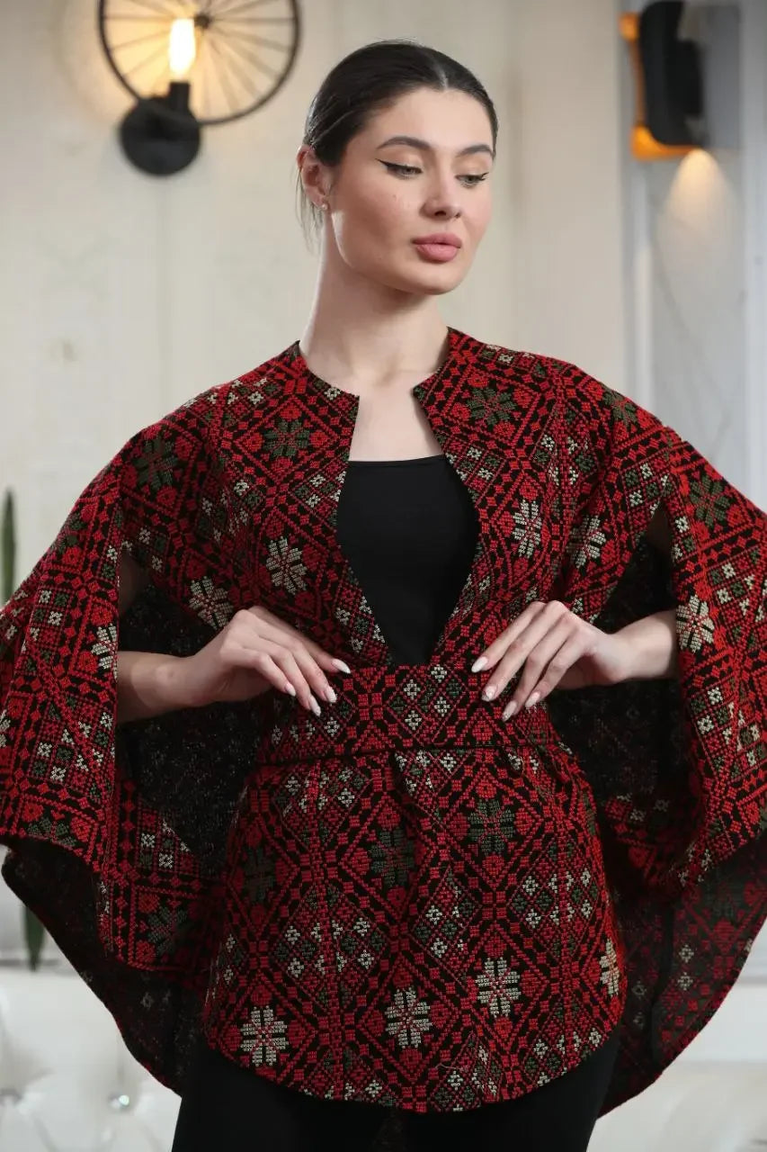 Palestinian Elegance woman wearing a red and black Palestinian tattreez cape with traditional embroidery