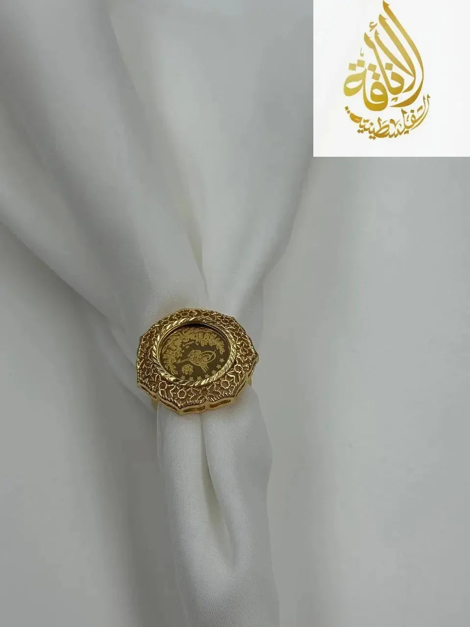 Palestinian Elegance falahi ring gold plated with intricate design on white fabric