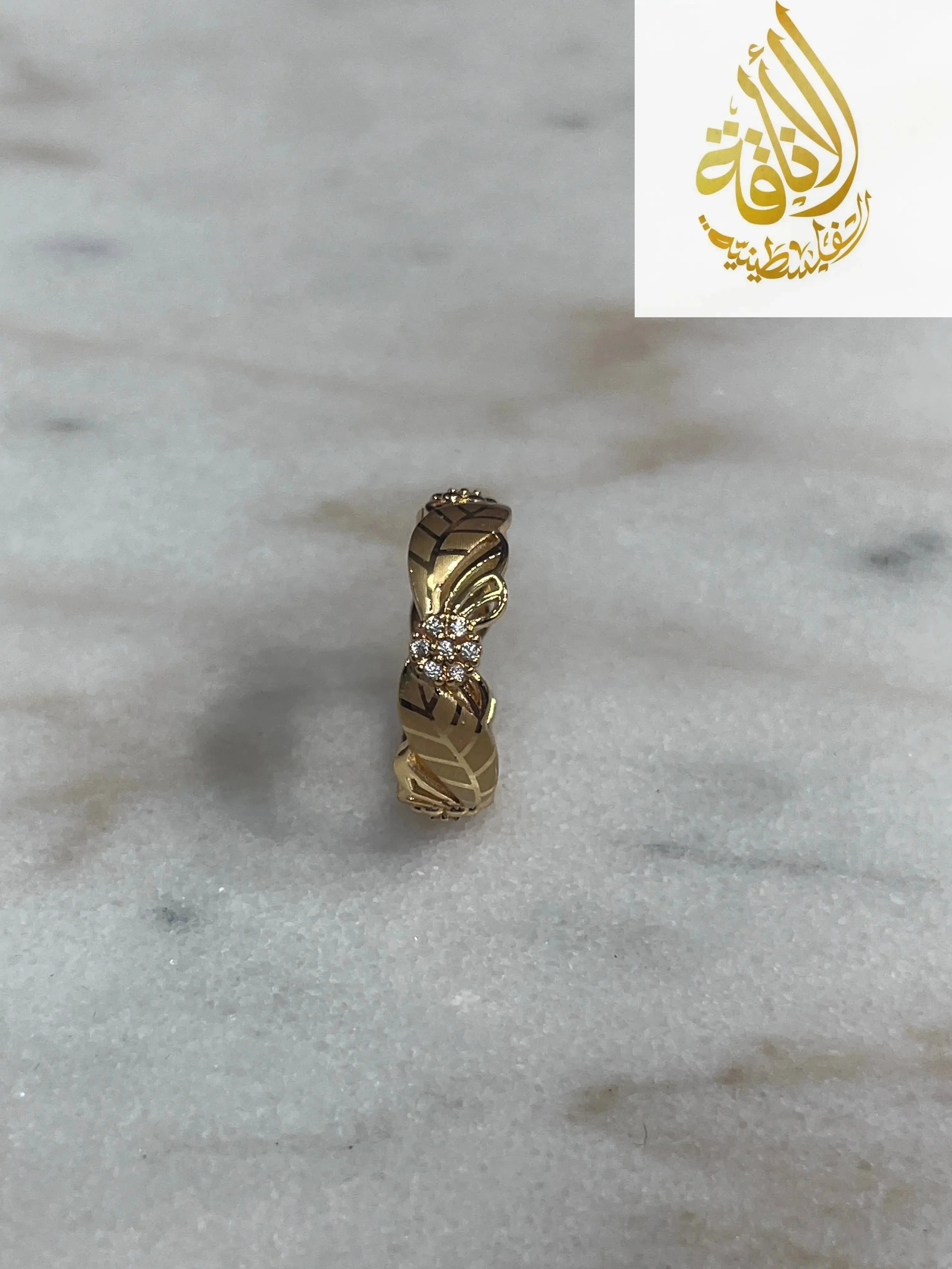 Imitated gold ring with intricate design and small stones from Palestinian Elegance heritage-inspired jewelry