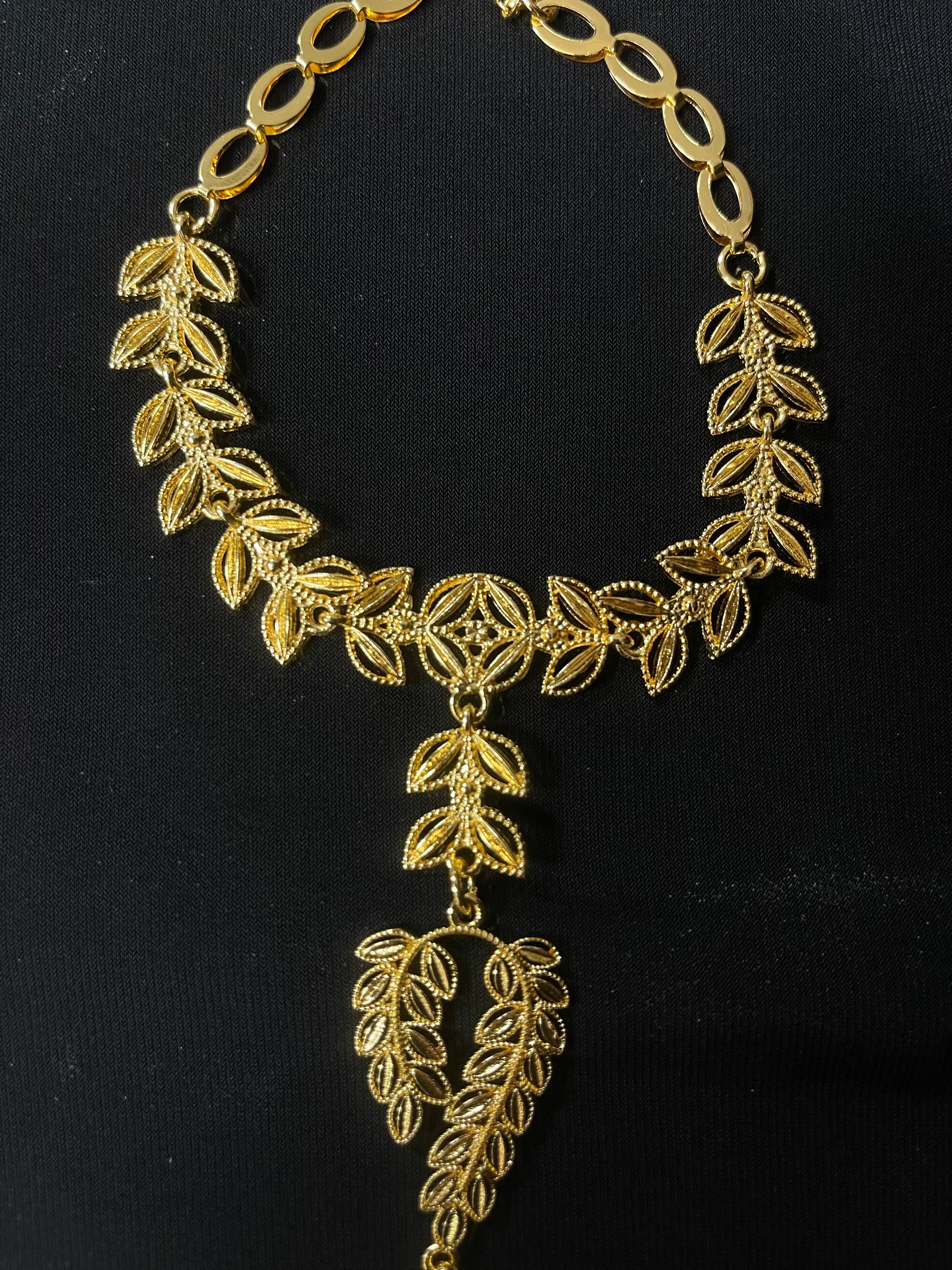 Palestinian Elegance imitation gold bracelet ring set with intricate leaf design on black background