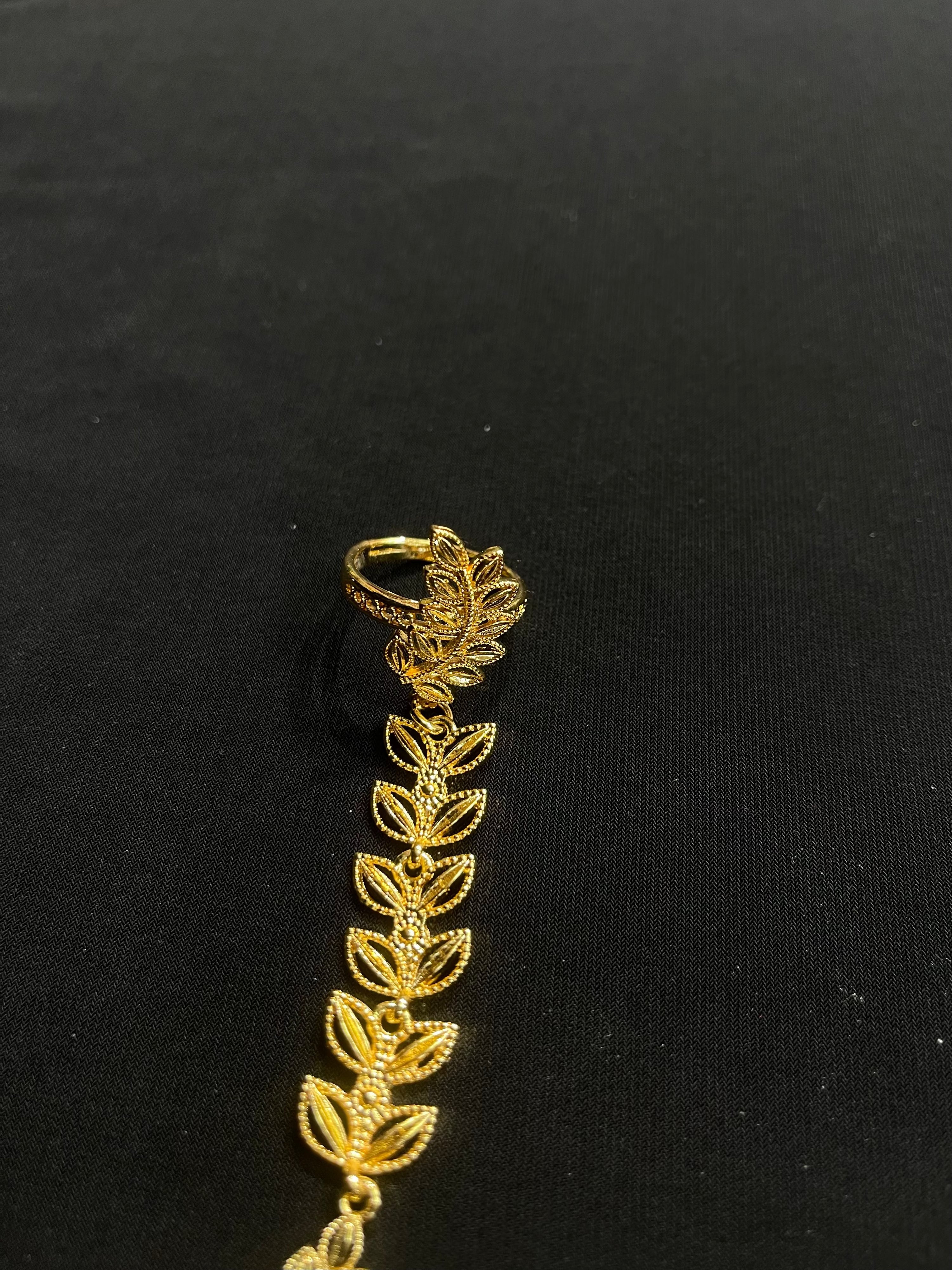 Palestinian Elegance imitation gold bracelet ring set with leaf design on black background