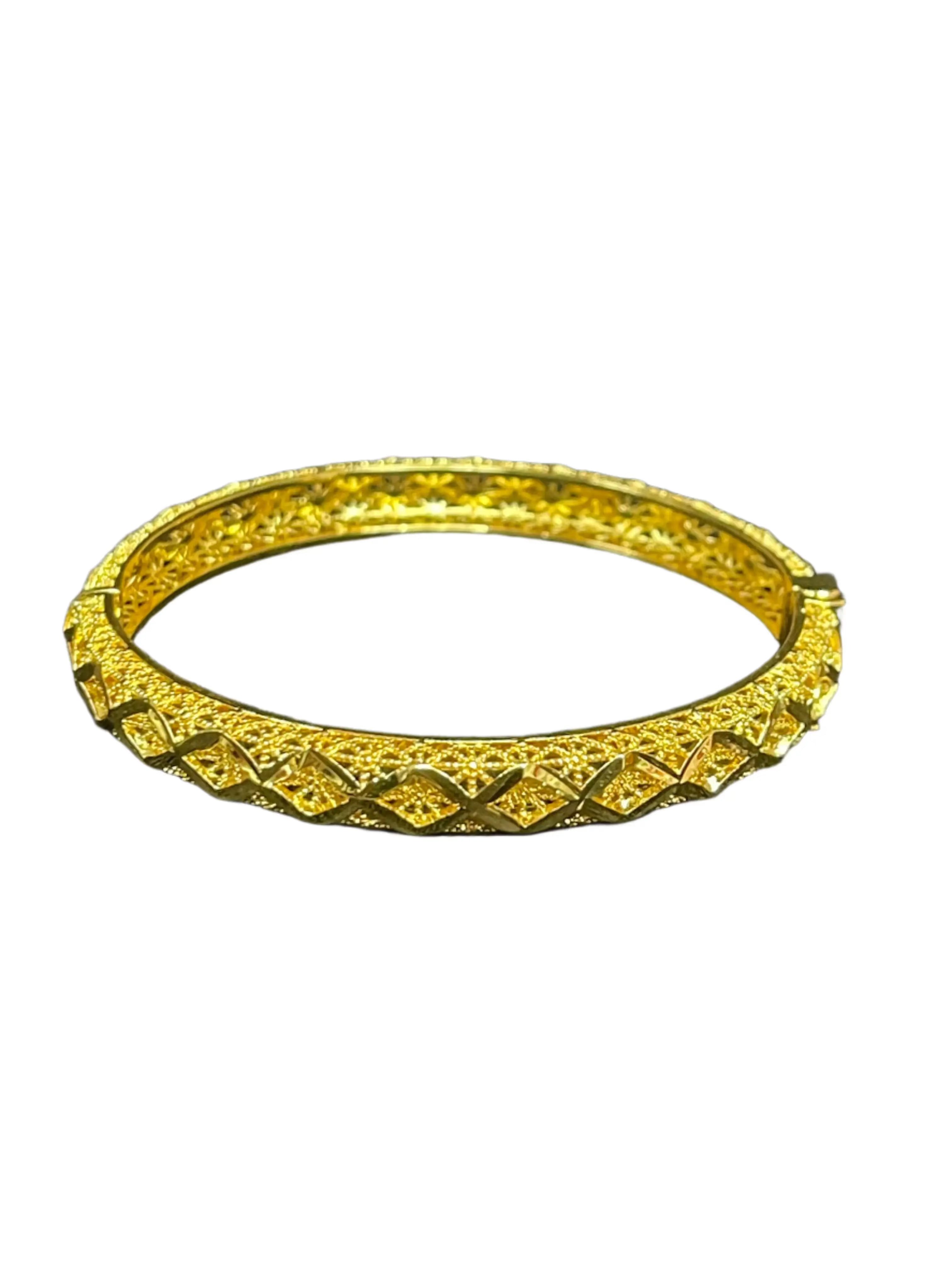 Palestinian Elegance imitation gold bangle with intricate textured design and shiny finish