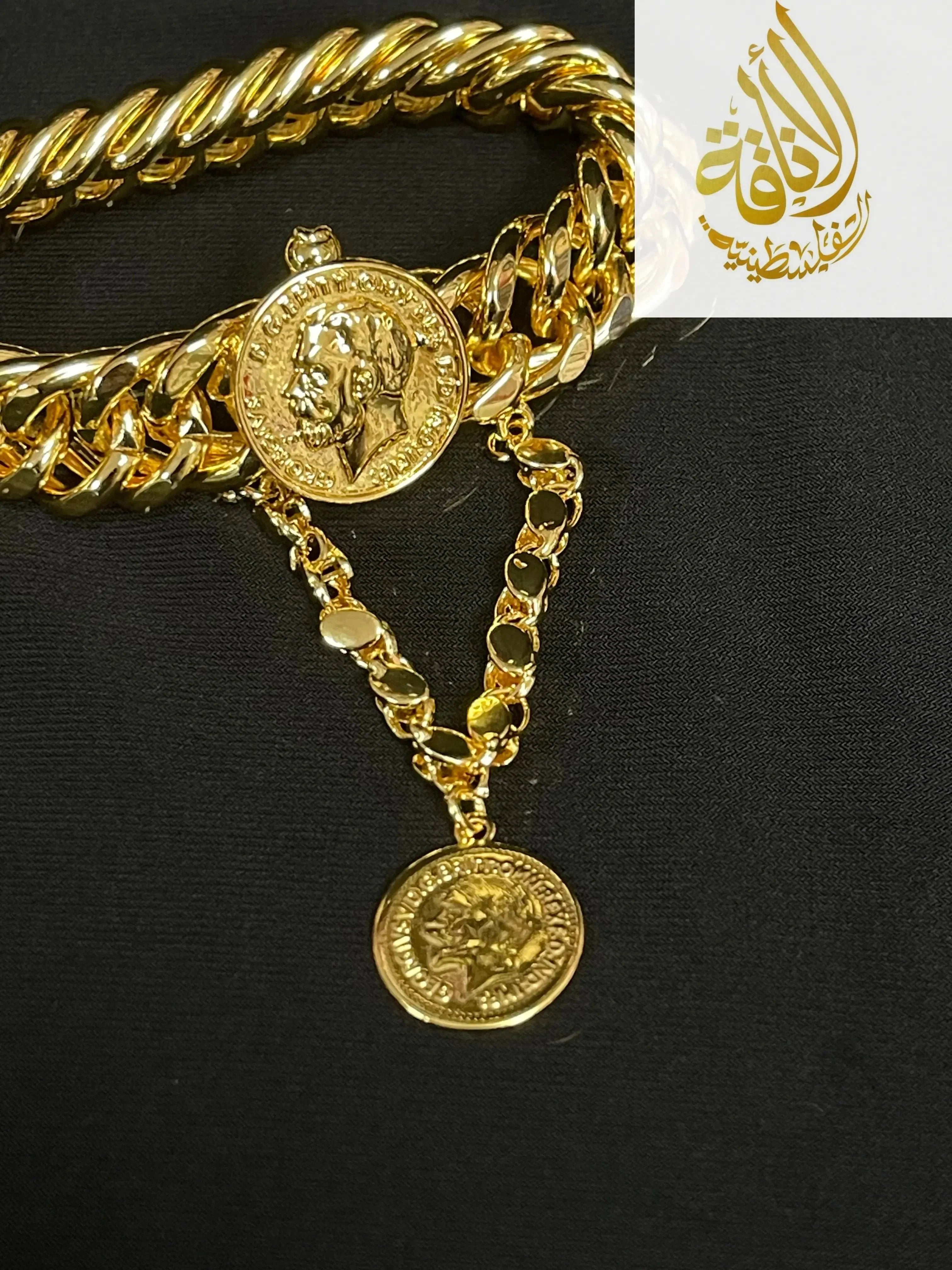 Imitated gold chain bracelet by Palestinian Elegance featuring coin charms on a black background