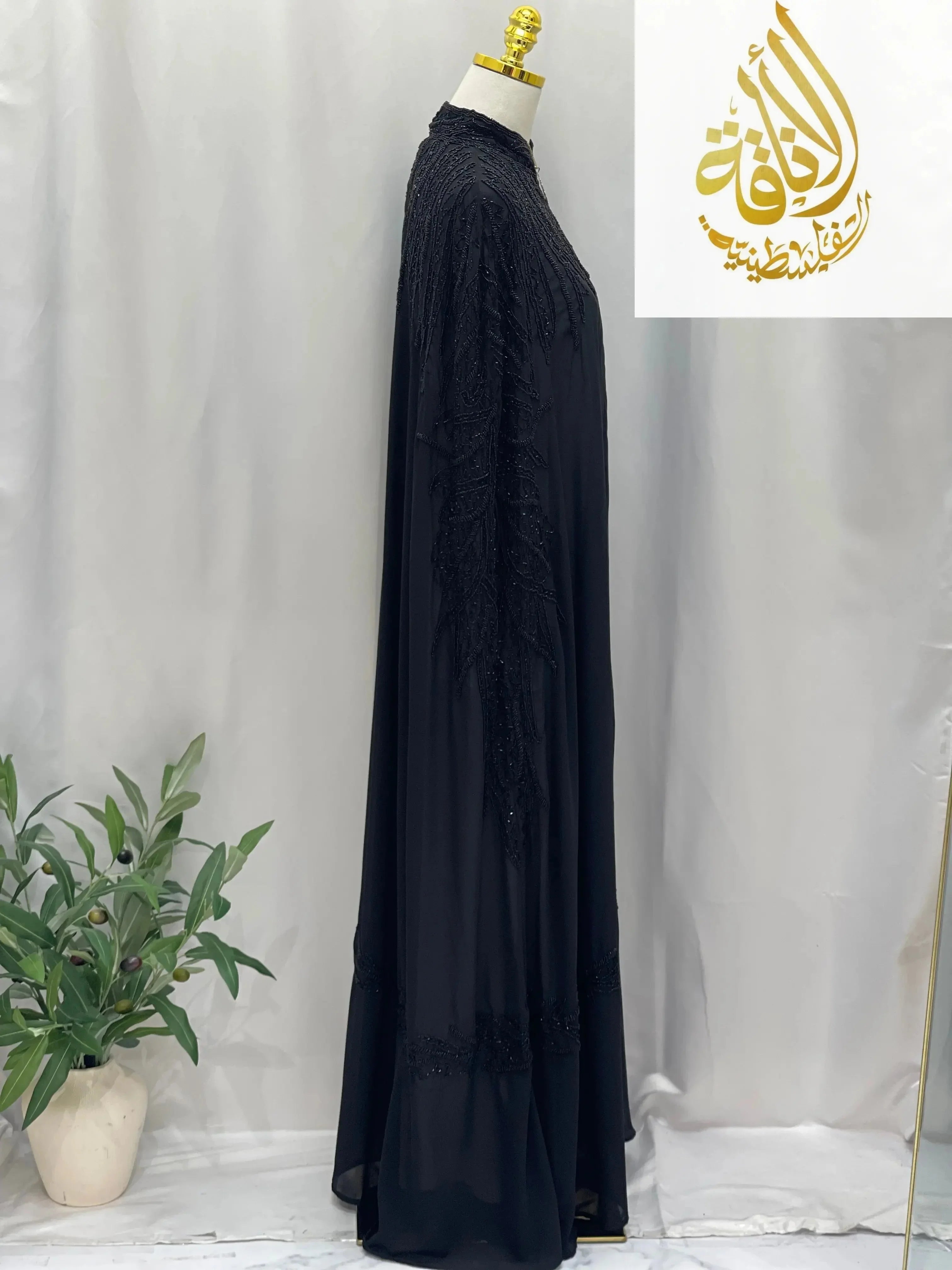 Palestinian Elegance black cardigan Karam Fancy Beads Cape with intricate beadwork on a mannequin